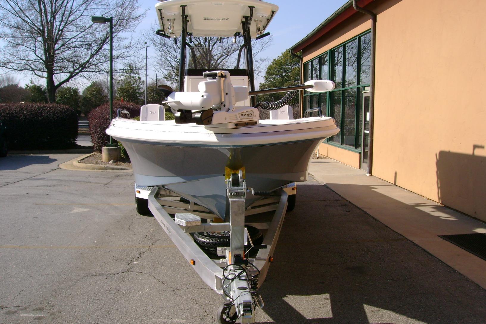 2026 Ranger 2360 Bay boat on trailer, parked near a building.