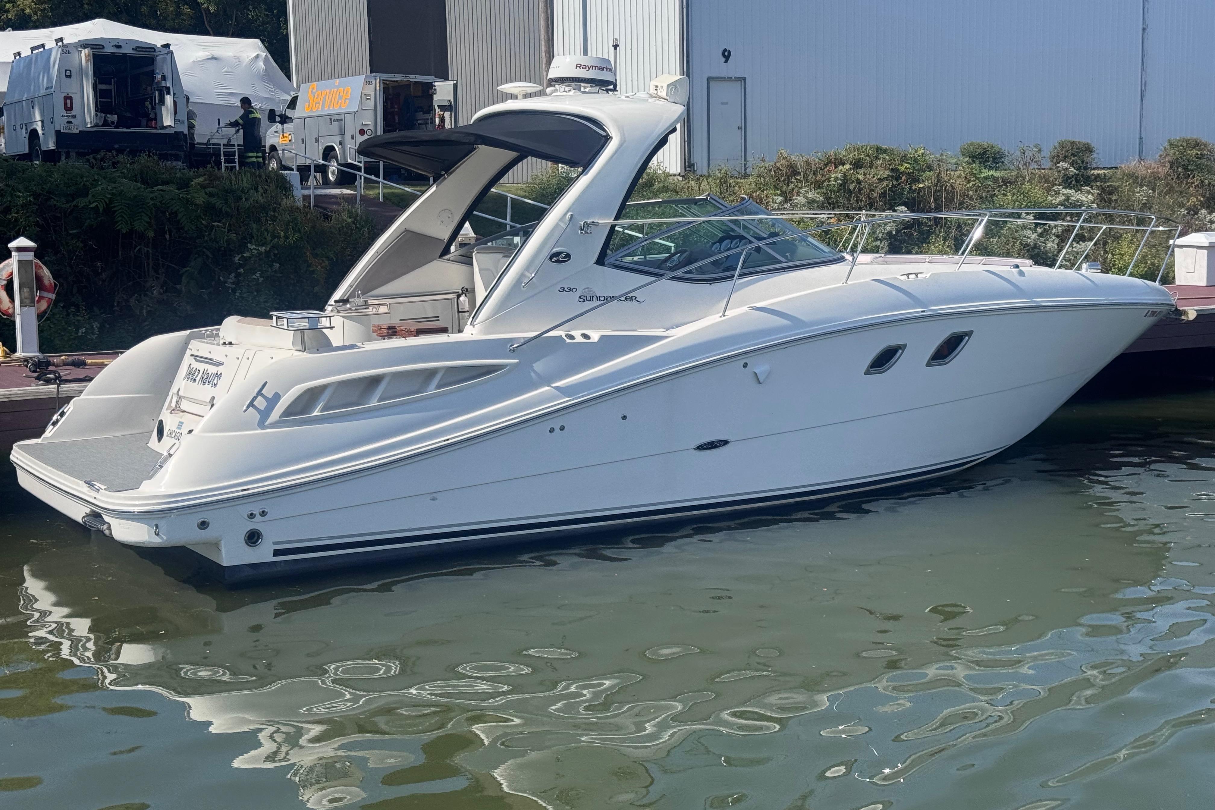 2008 Sea Ray 350 Sundancer yacht docked at marina, side view.