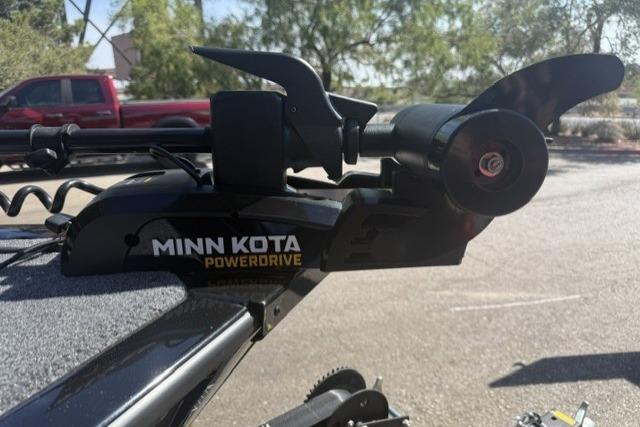 Minn Kota PowerDrive motor on 2026 Tracker Super Guide V-16 SC boat, parked outdoors.
