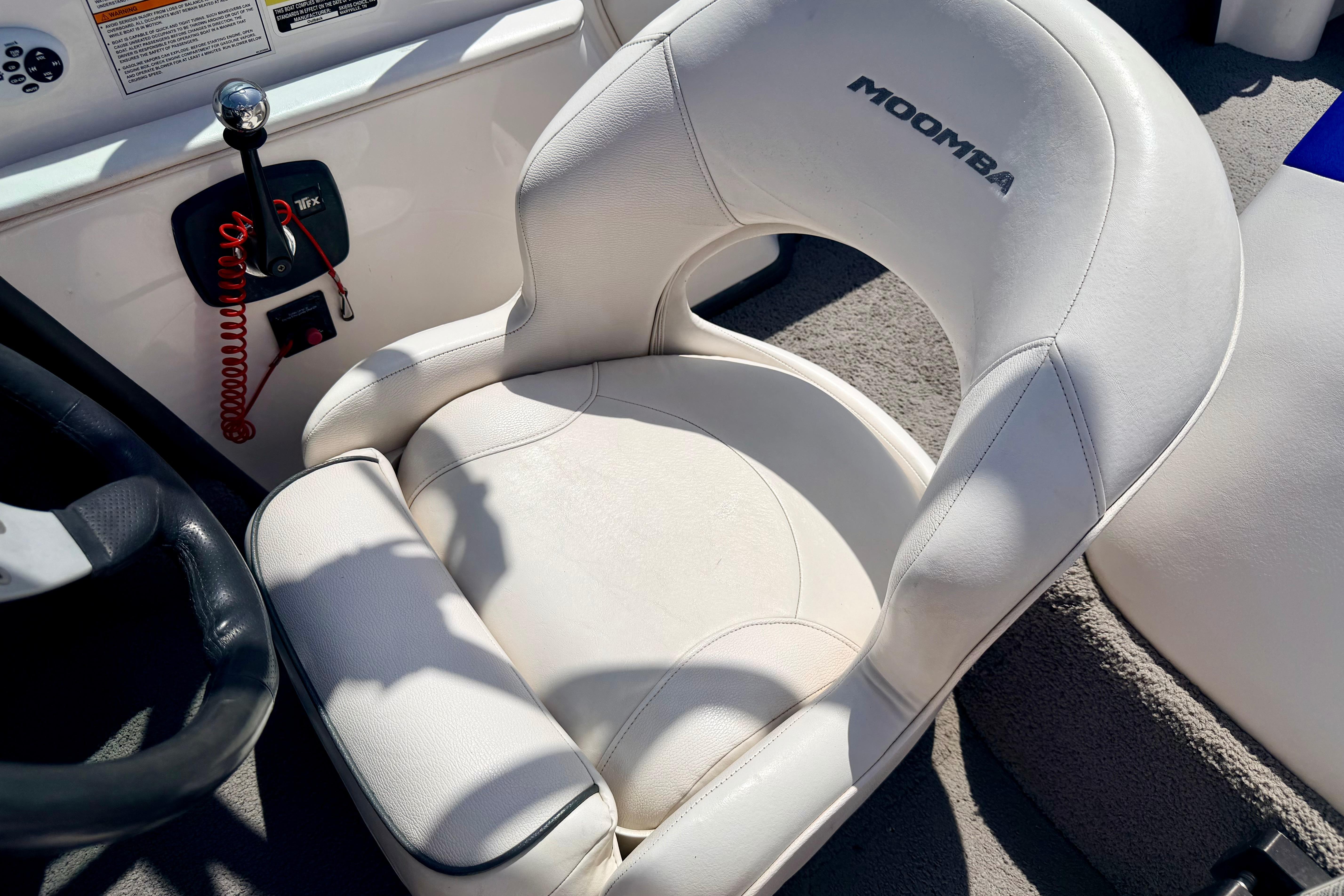 2008 Moomba Outback V boat interior with white captain's chair and control panel.