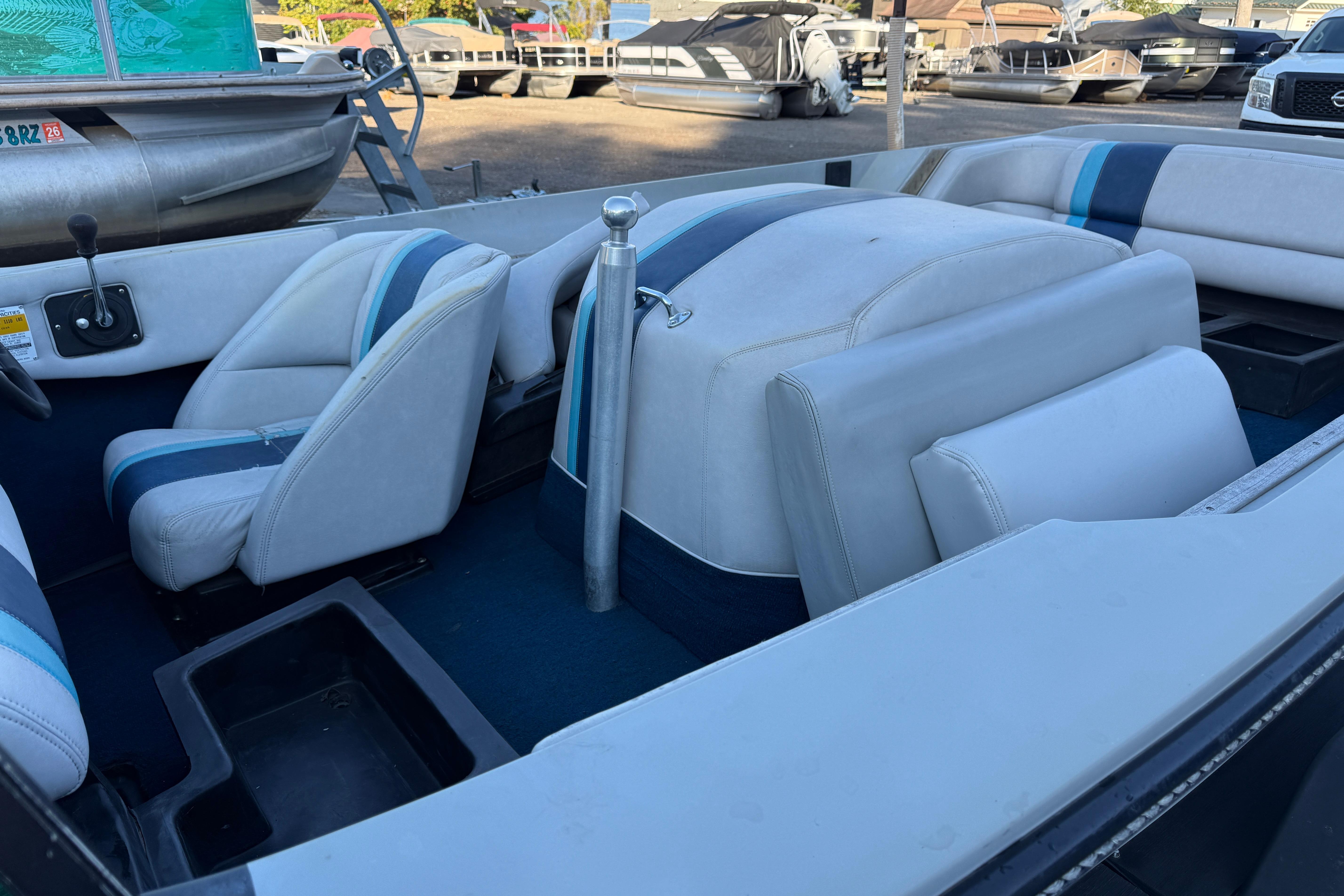 1989 Correct Craft Ski Nautique interior with blue and white seating, parked outdoors.