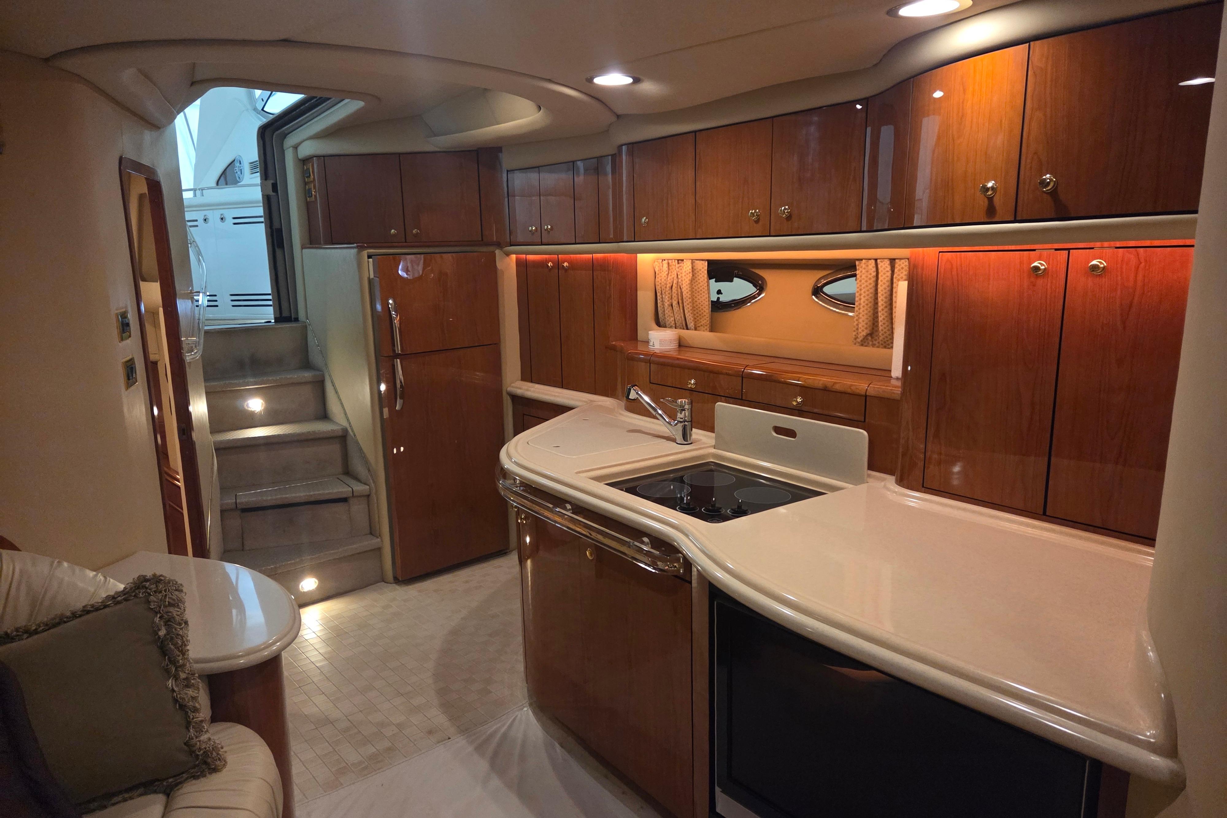 Luxurious interior of 2000 Sea Ray Sundancer 540 yacht with elegant wood cabinetry.