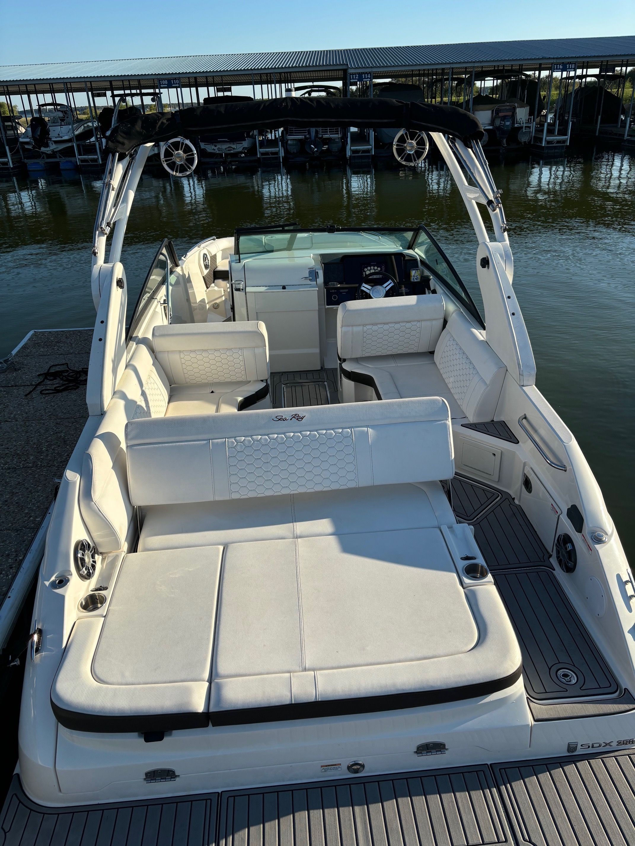 2019 Sea Ray SDX 250 boat docked with luxurious interior seating.