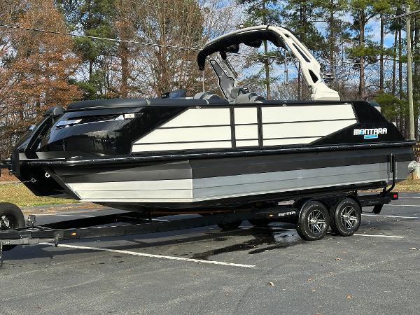 2025 Montara Surf Boss 2.0 25 boat on trailer, parked outdoors.