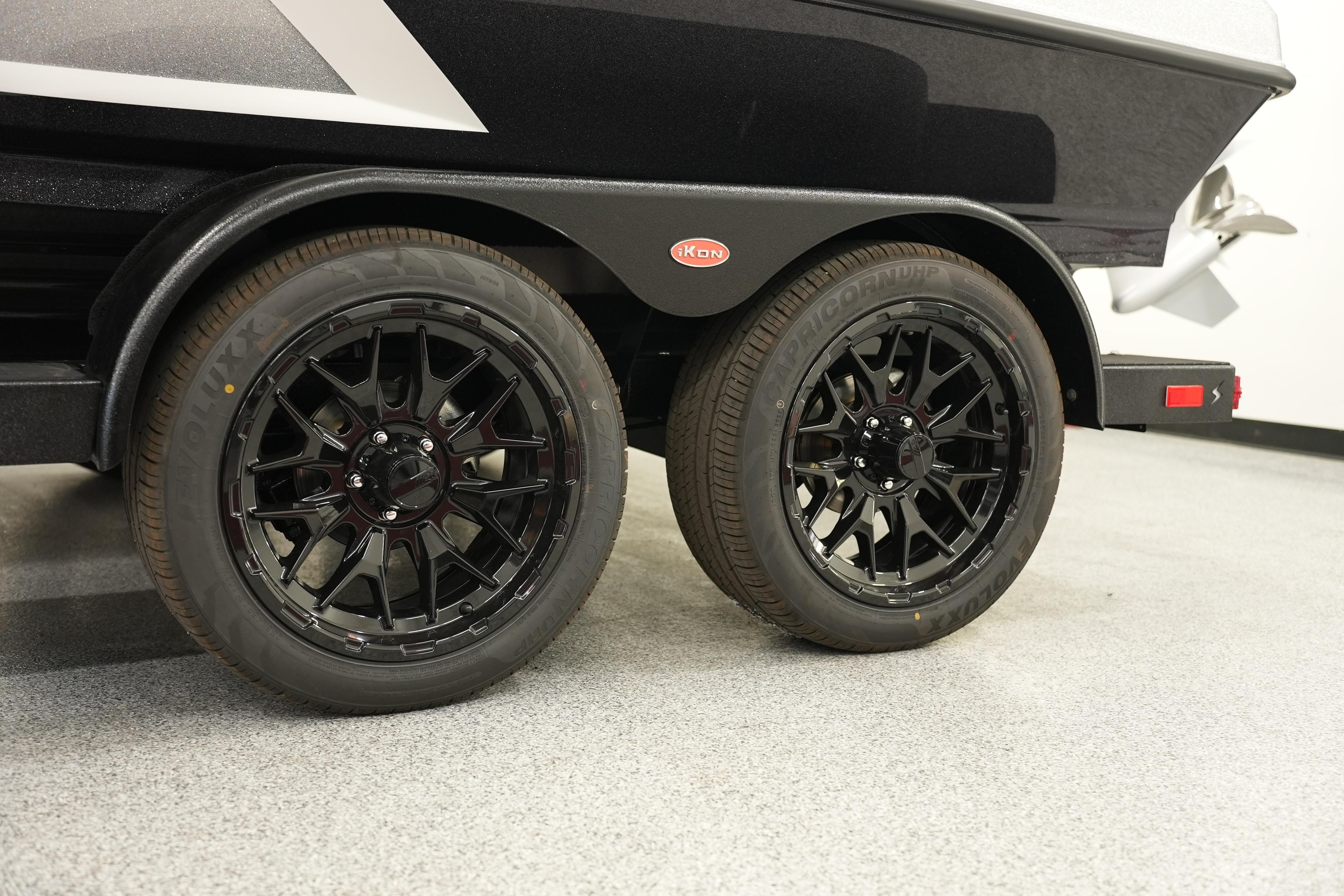 2026 iKon LXE20 trailer with black alloy wheels on a showroom floor.