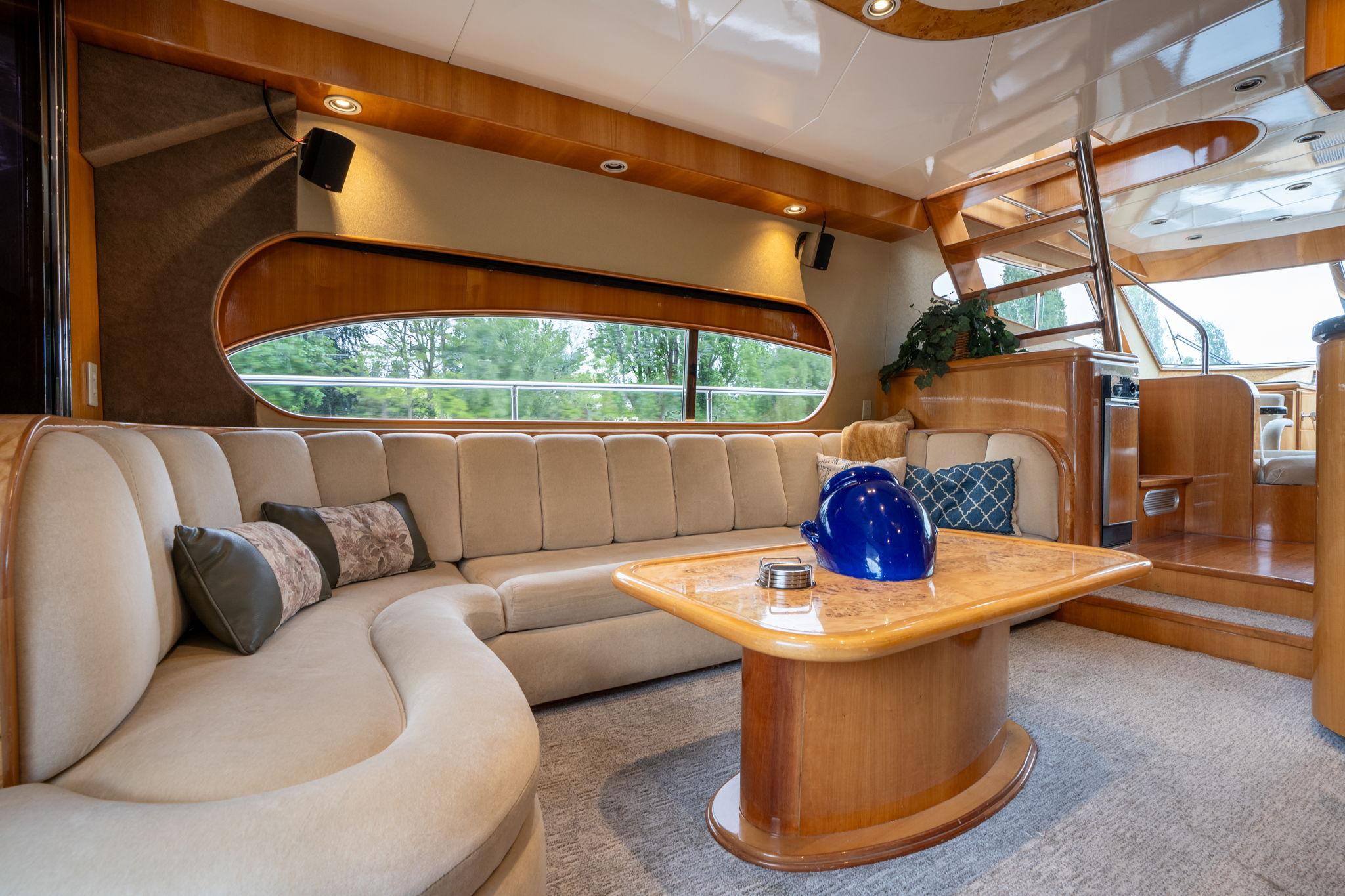 Luxurious interior of 1999 Vitech 68' Pilothouse yacht with elegant seating and wooden accents.