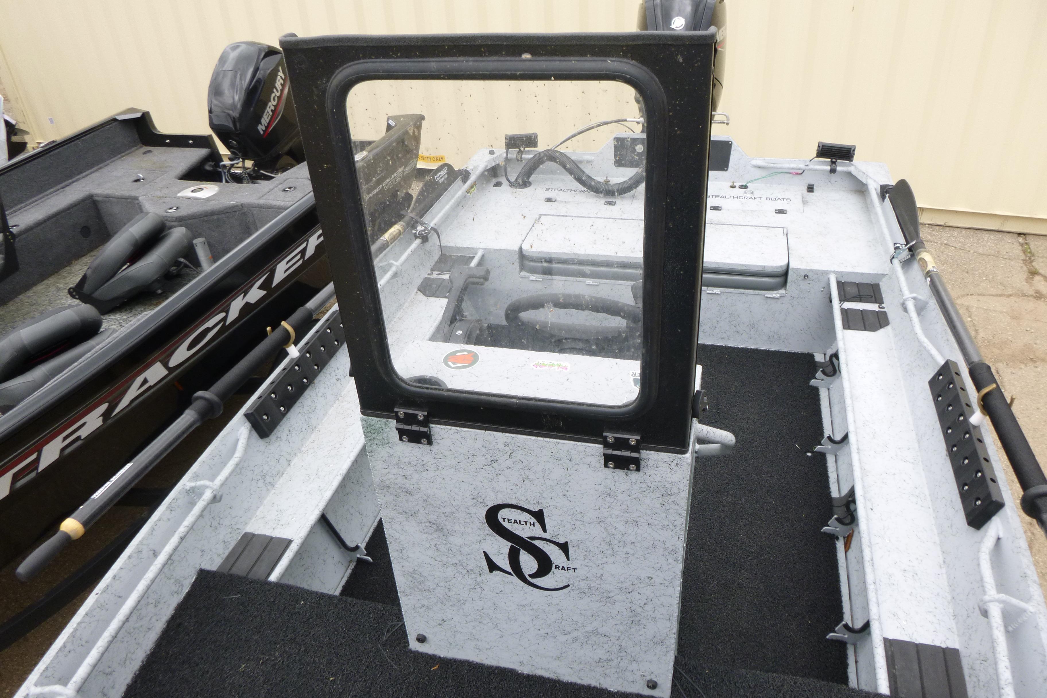 2025 StealthCraft 16 StealthWeld boat interior with steering console and seating.