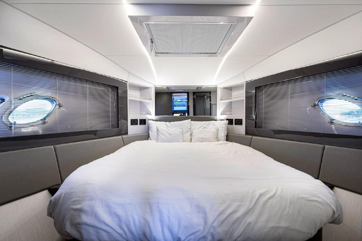 Luxurious bedroom interior of 2018 Pershing 5x yacht with modern design and cozy bedding.