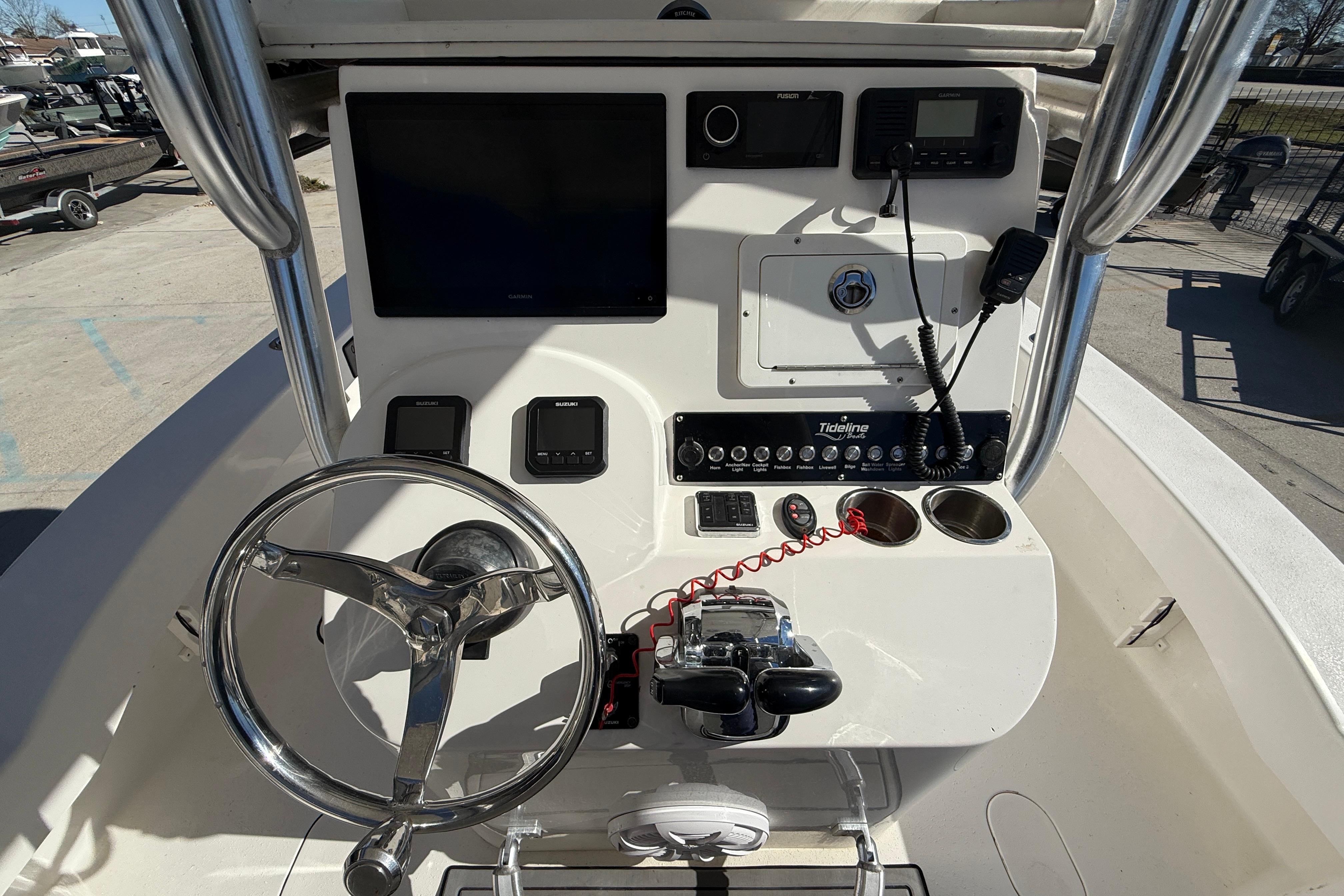 2020 Tideline 235 Hybrid boat console with steering wheel and navigation controls.