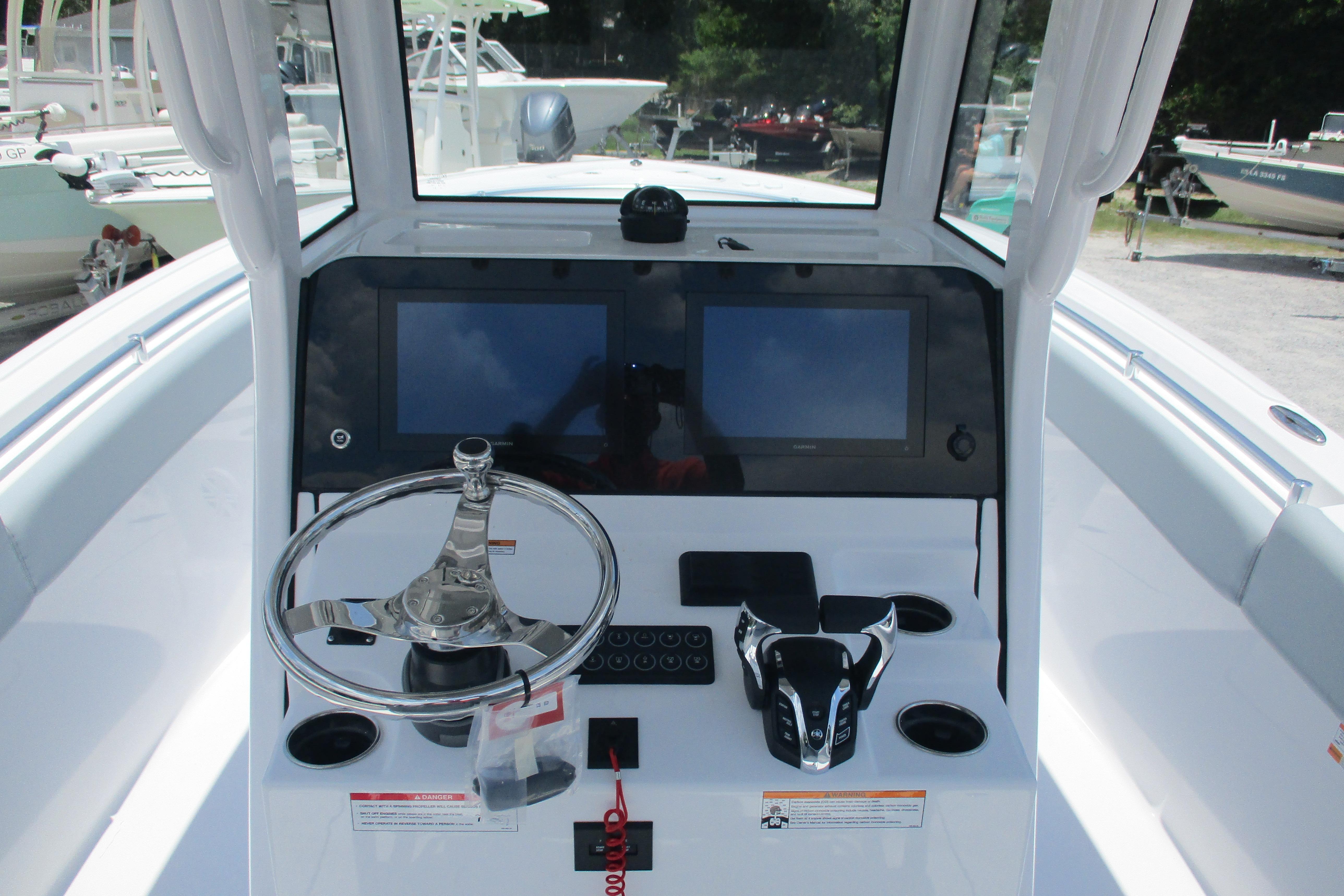 2027 Sportsman Open 252 Center Console boat dashboard with steering wheel and dual screens.