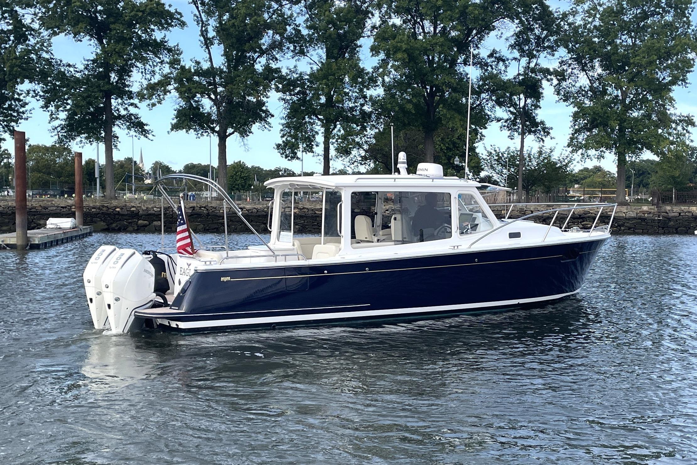 2023 MJM 35 boat on water, featuring sleek design and dual outboard engines.