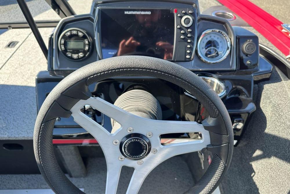 Steering wheel and dashboard of 2026 Starweld 17 SXT boat with navigation controls.
