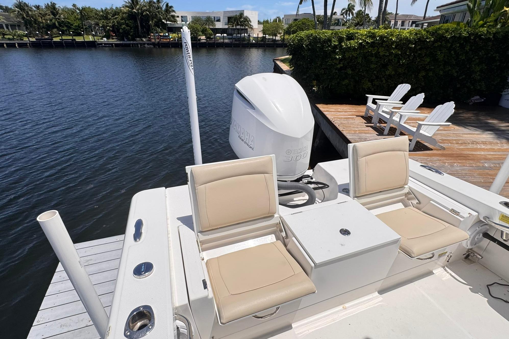 2018 Everglades 253 Center Console boat docked by waterfront with Yamaha engine.