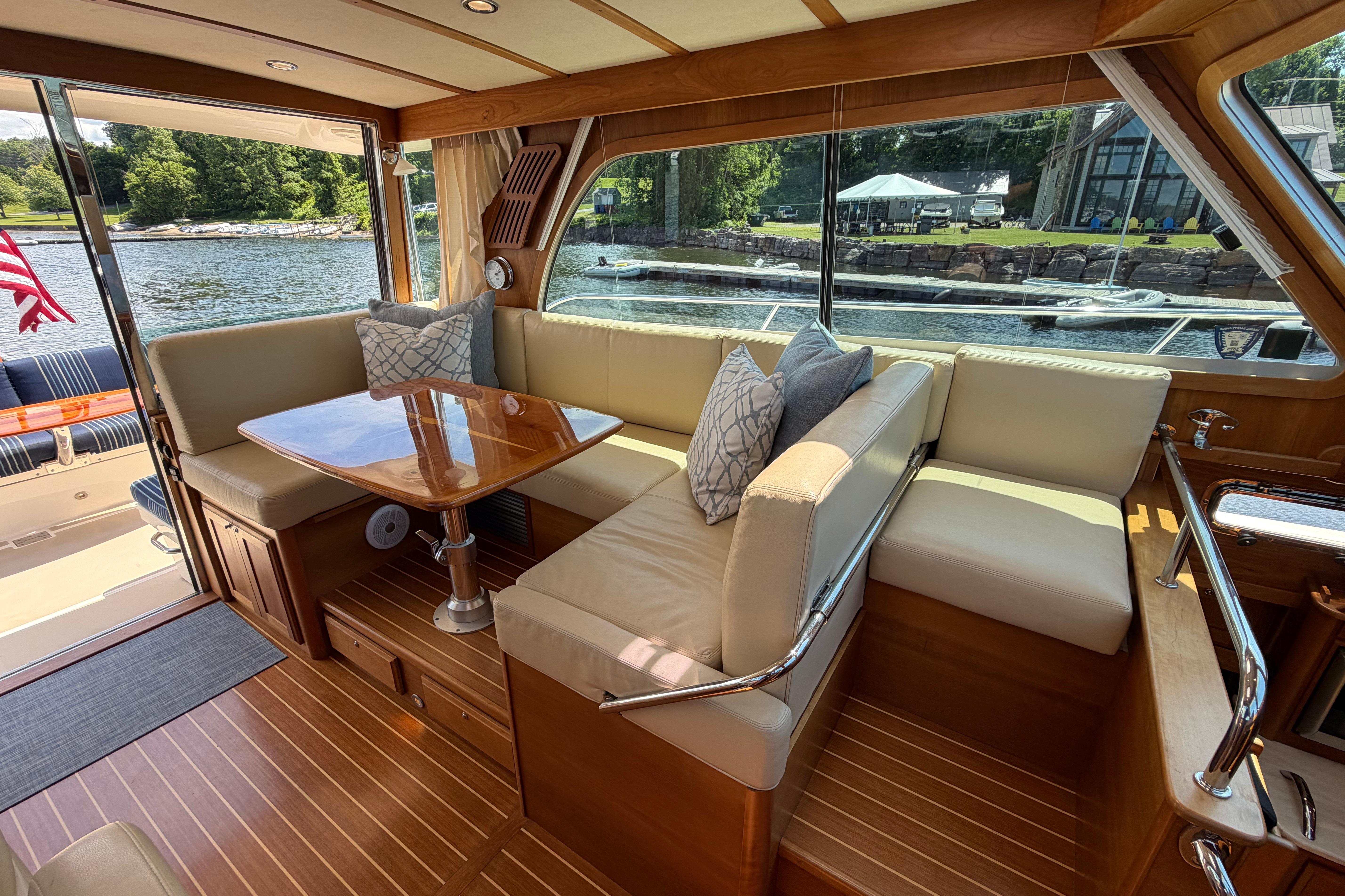 Luxurious interior of 2015 Sabre 38 Salon Express yacht with elegant seating and table.