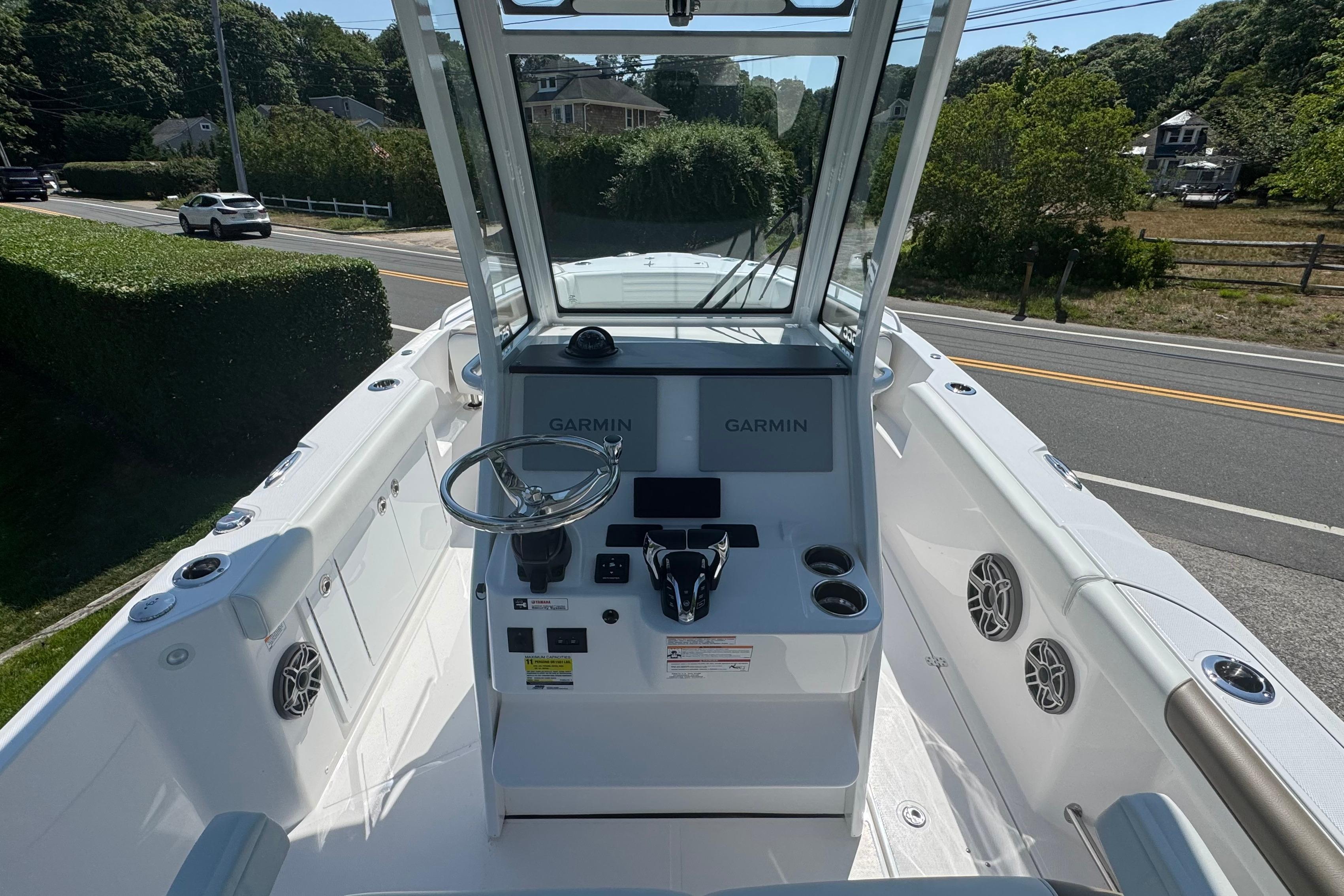 2026 Edgewater 250CC boat cockpit with Garmin navigation, steering wheel, and modern controls.