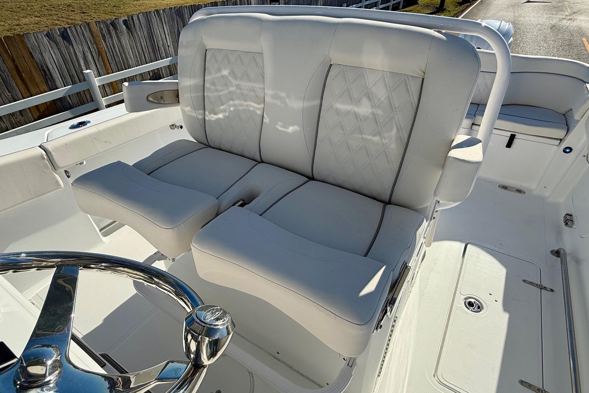 2026 Sea Hunt Ultra 275 Coffin Box boat interior with plush seating and steering wheel.
