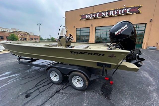 2026 Tracker Grizzly 2072 CC boat on trailer outside boat service center.