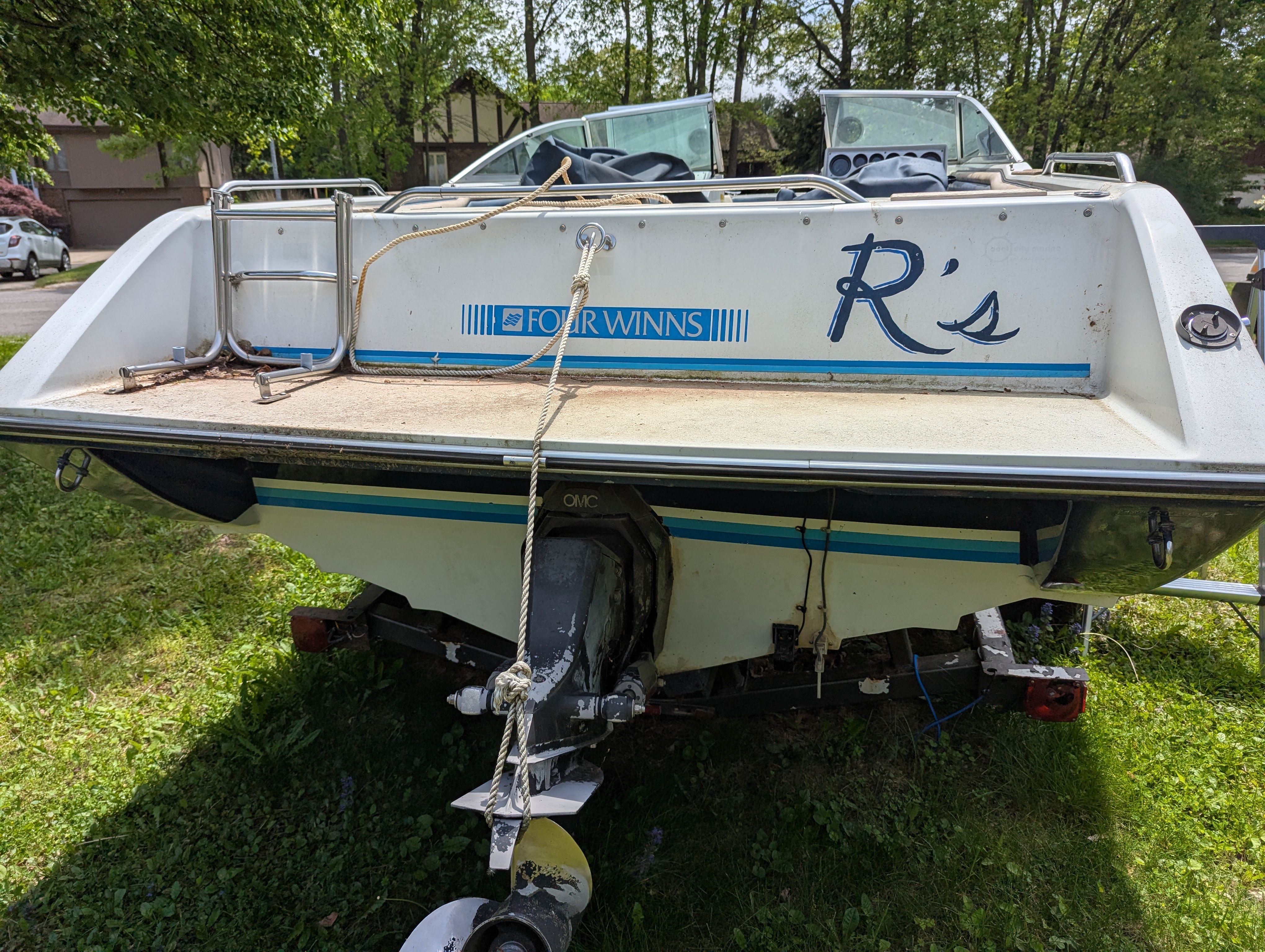 1988 Four Winns 200 Horizon boat parked on grass.