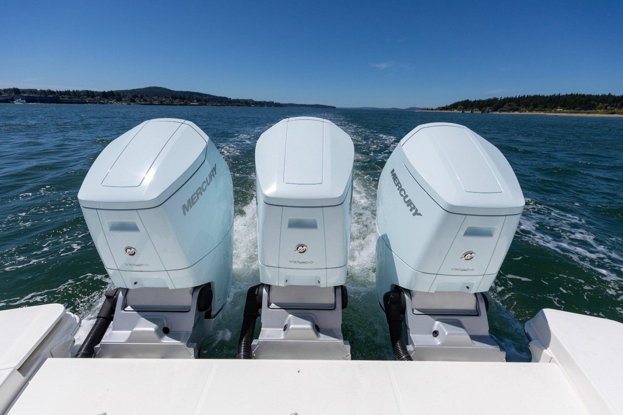 2023 Boston Whaler 405 Conquest with triple Mercury outboard engines on open water.