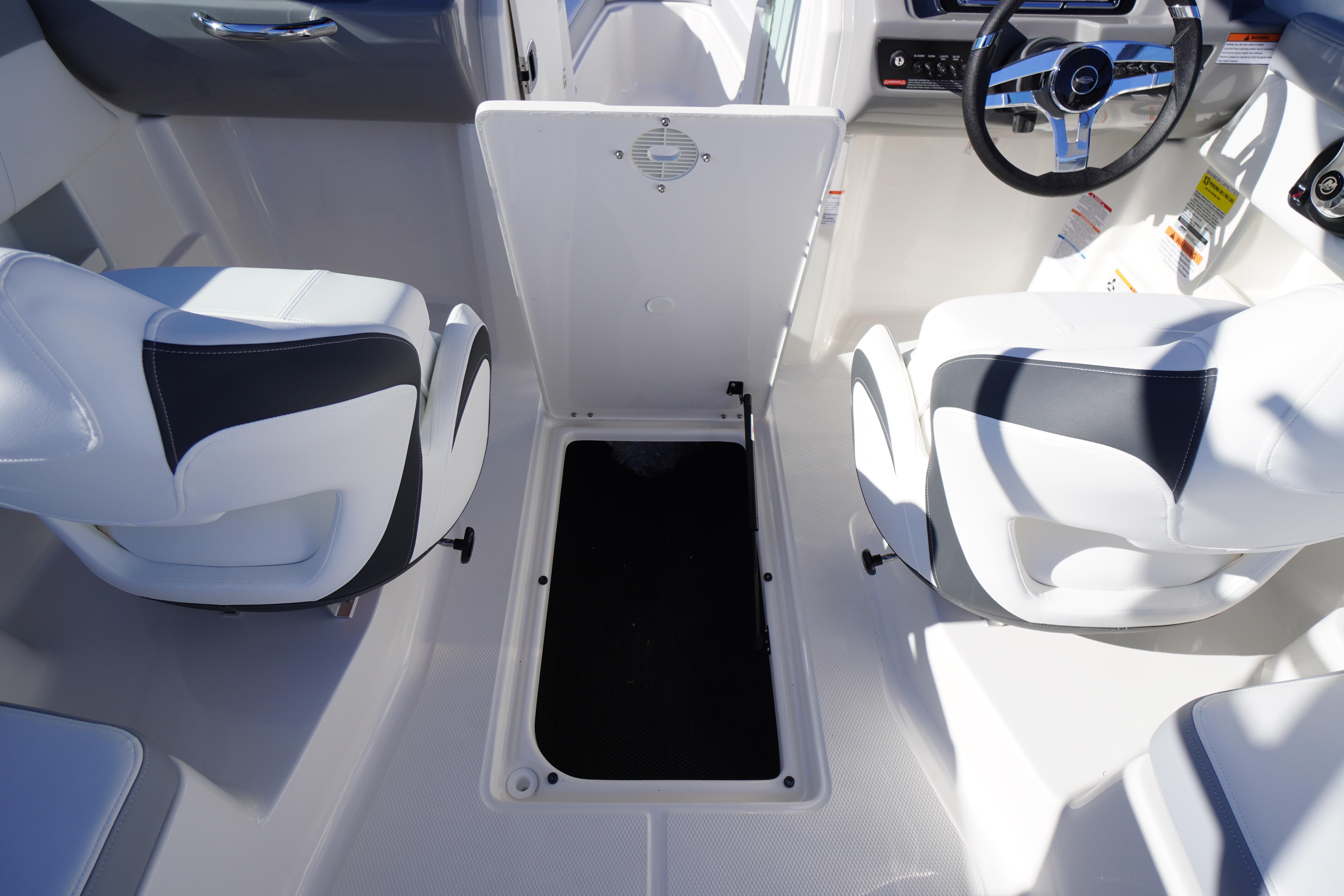 2026 Chaparral 23 SSi boat interior with white seating and storage compartment.