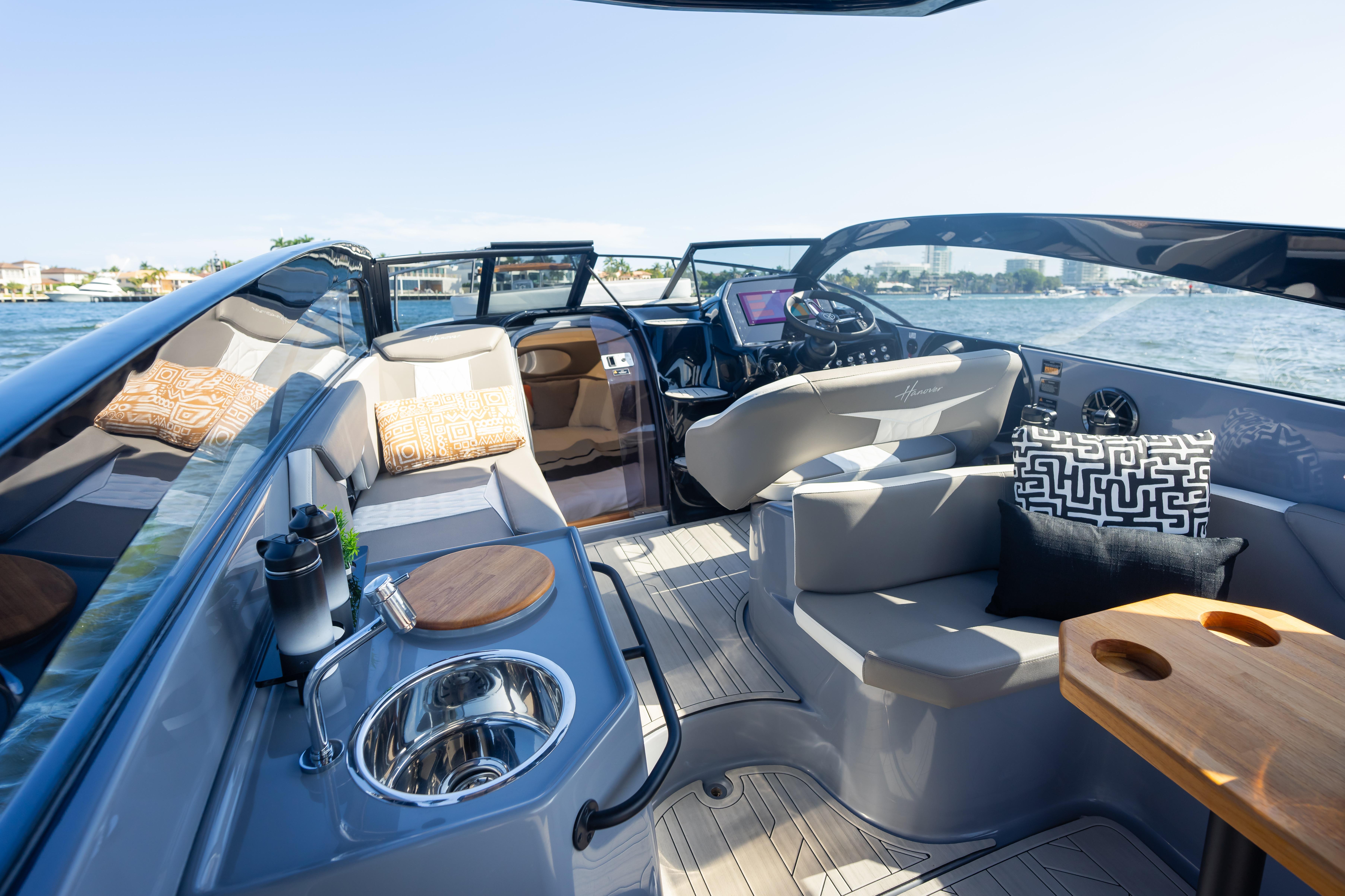 Luxurious interior of 2026 Hanover 305 boat with modern seating and amenities on open water.