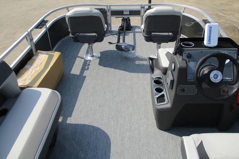 2026 Sun Tracker Bass Buggy 16 XL Select pontoon boat interior with seating and steering console.