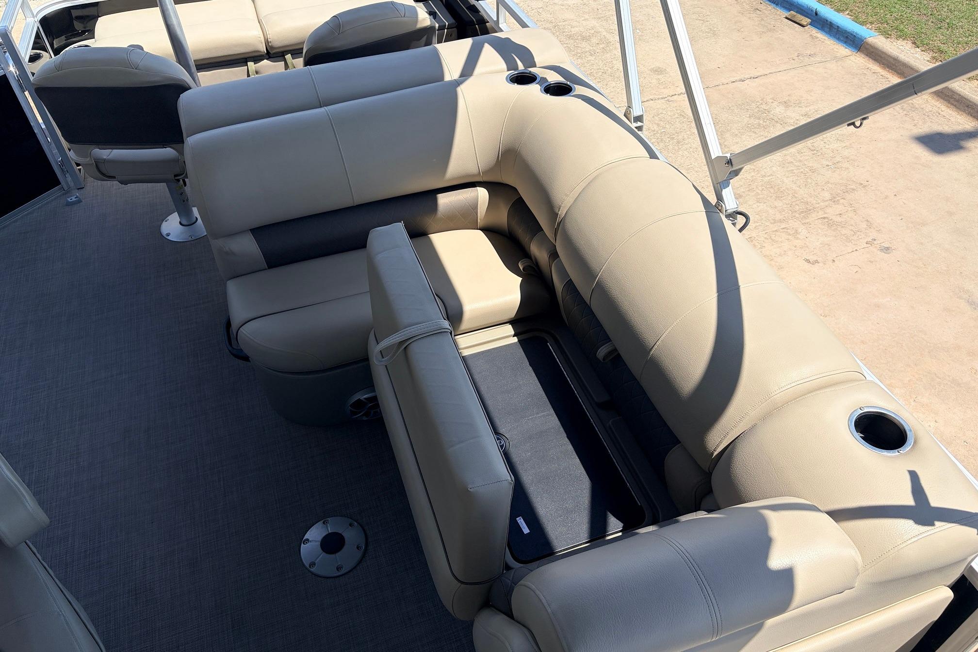 2024 Sun Tracker SportFish 22 XP3 boat interior with beige seating and cup holders.