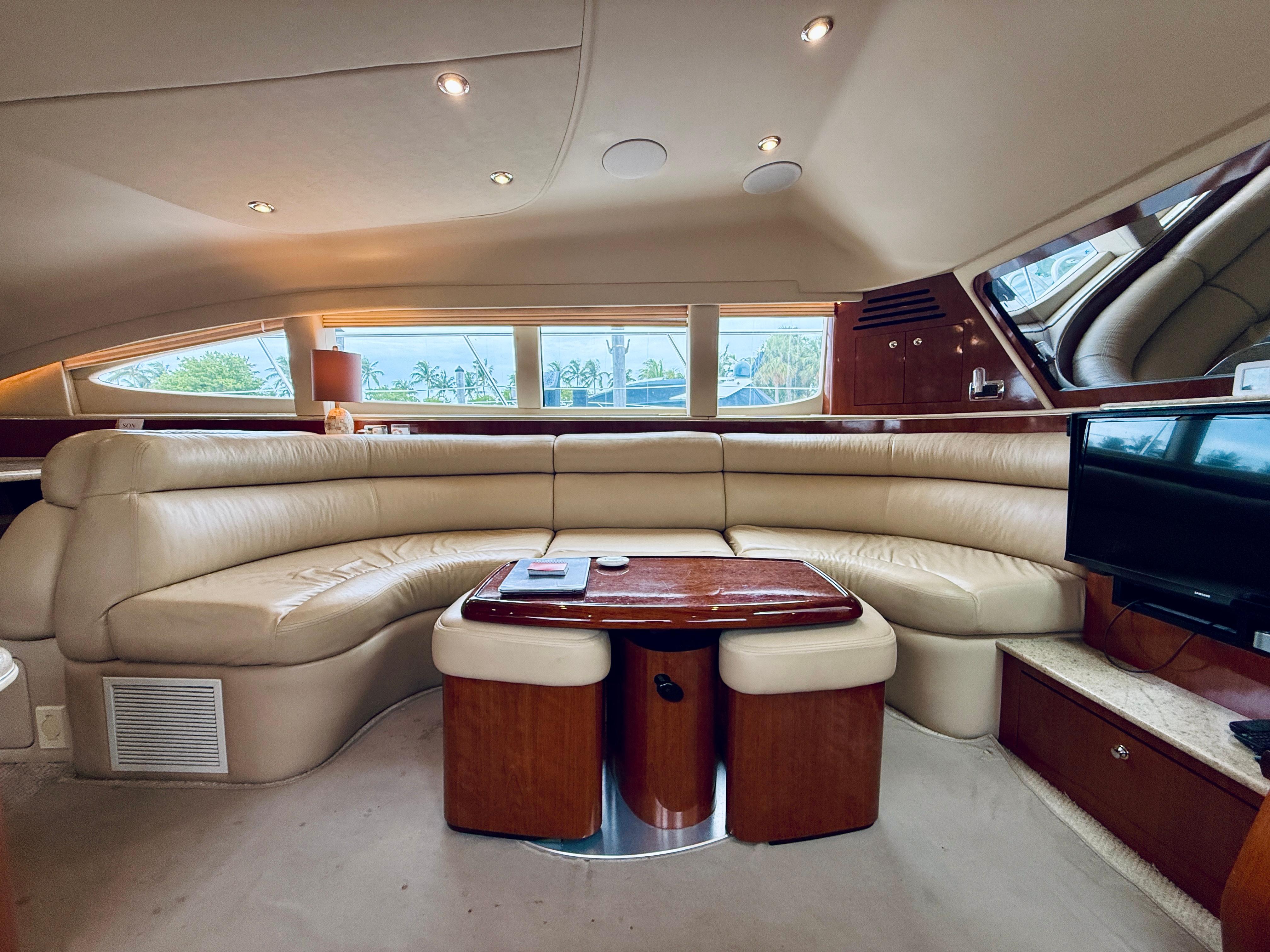 Luxurious interior of 2003 Sea Ray 480 Motor Yacht with plush seating and elegant wood finishes.