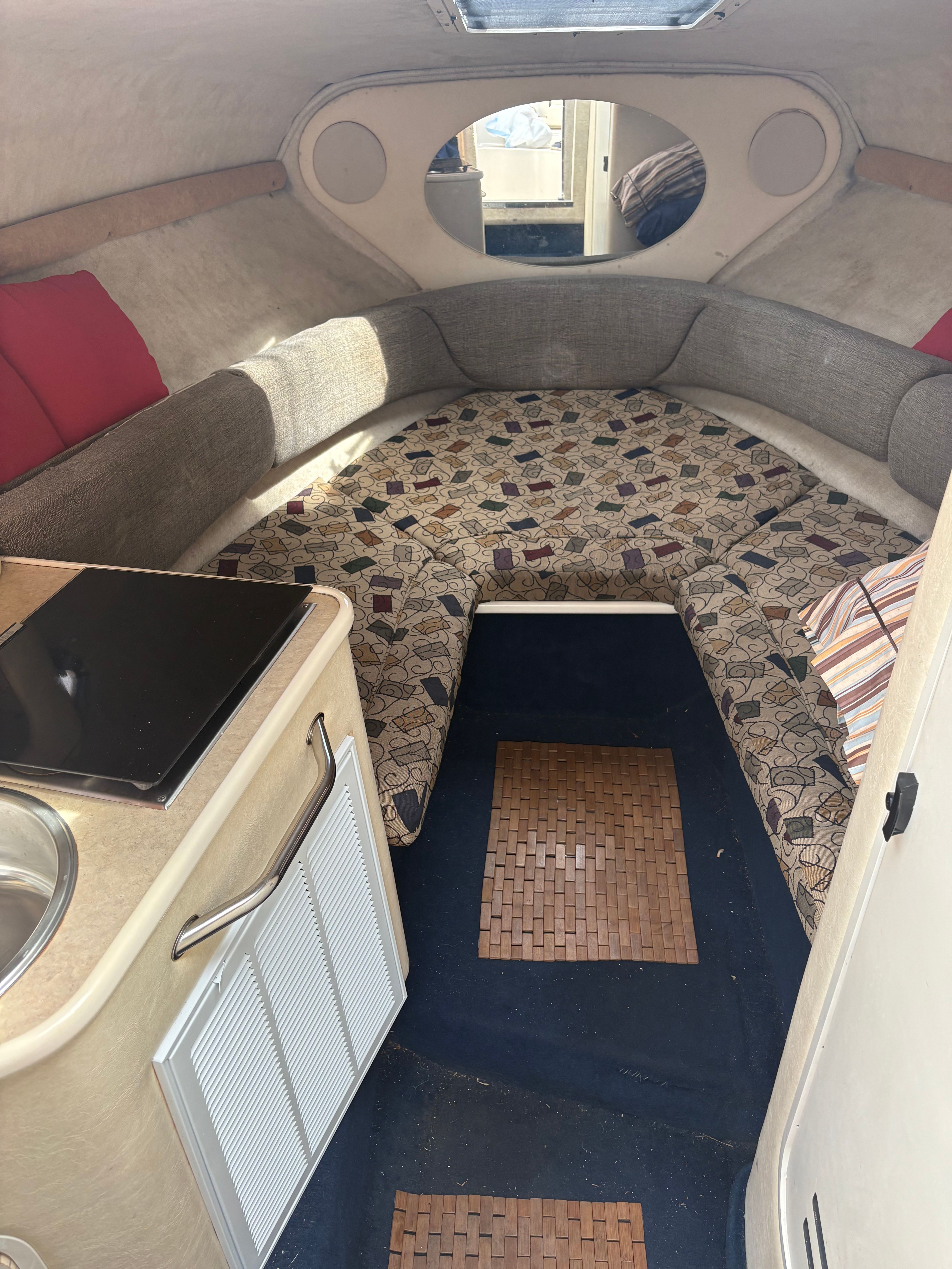 Interior of the 2001 Sea Ray 240 Sundancer with cozy cabin and kitchenette.