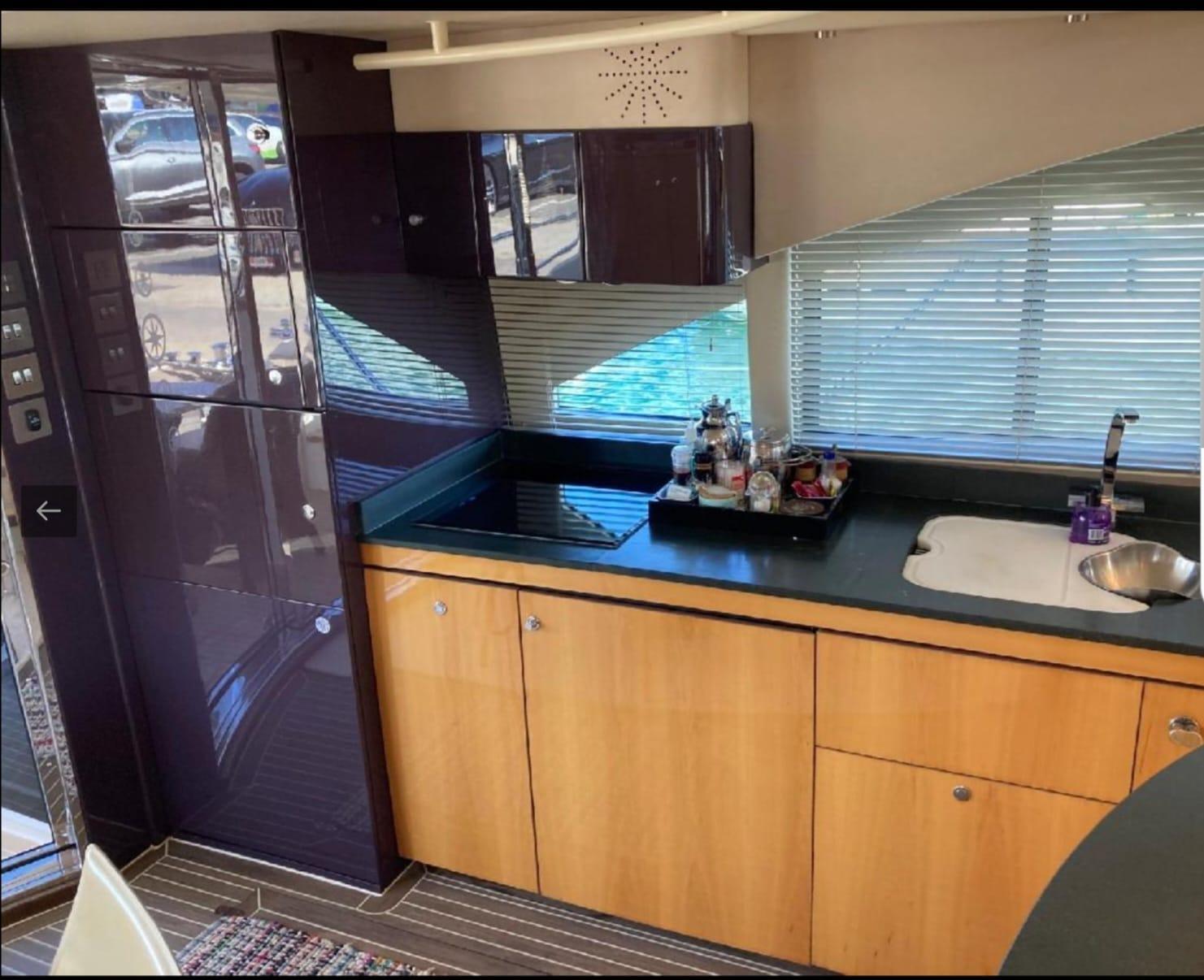 Luxurious kitchen interior of a 2005 Sealine T60 yacht with modern amenities.