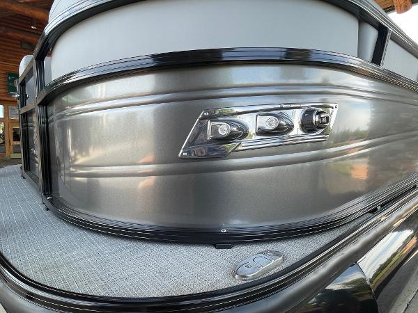2024 Regency 230 DL3 pontoon boat with sleek metallic exterior and modern lighting.