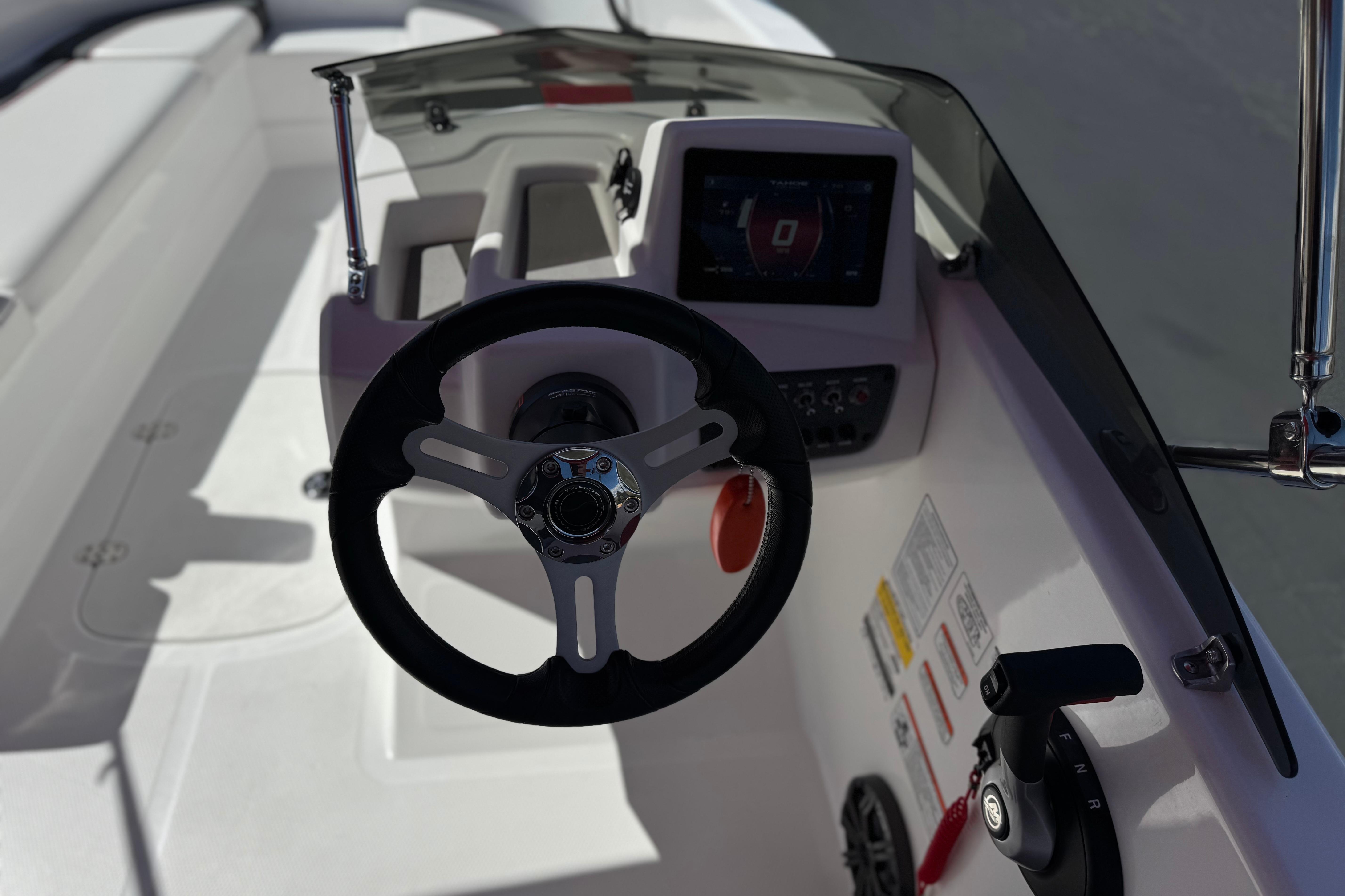 2024 Tahoe T16 boat dashboard with steering wheel and control panel.