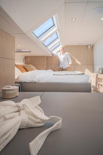 Luxurious interior of 2025 Privilege Signature 650 yacht with skylight and modern design.