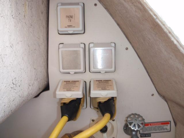 Electrical and communication outlets on a 1999 Sea Ray 410 Express Cruiser.