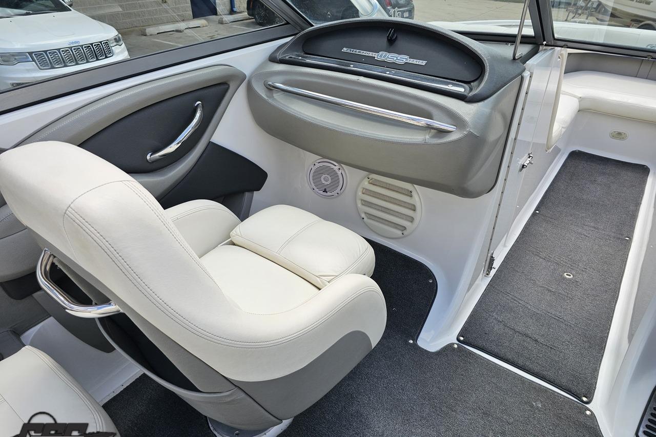 Interior of a 2010 Cobalt 232 WSS boat, featuring white seating and dashboard.