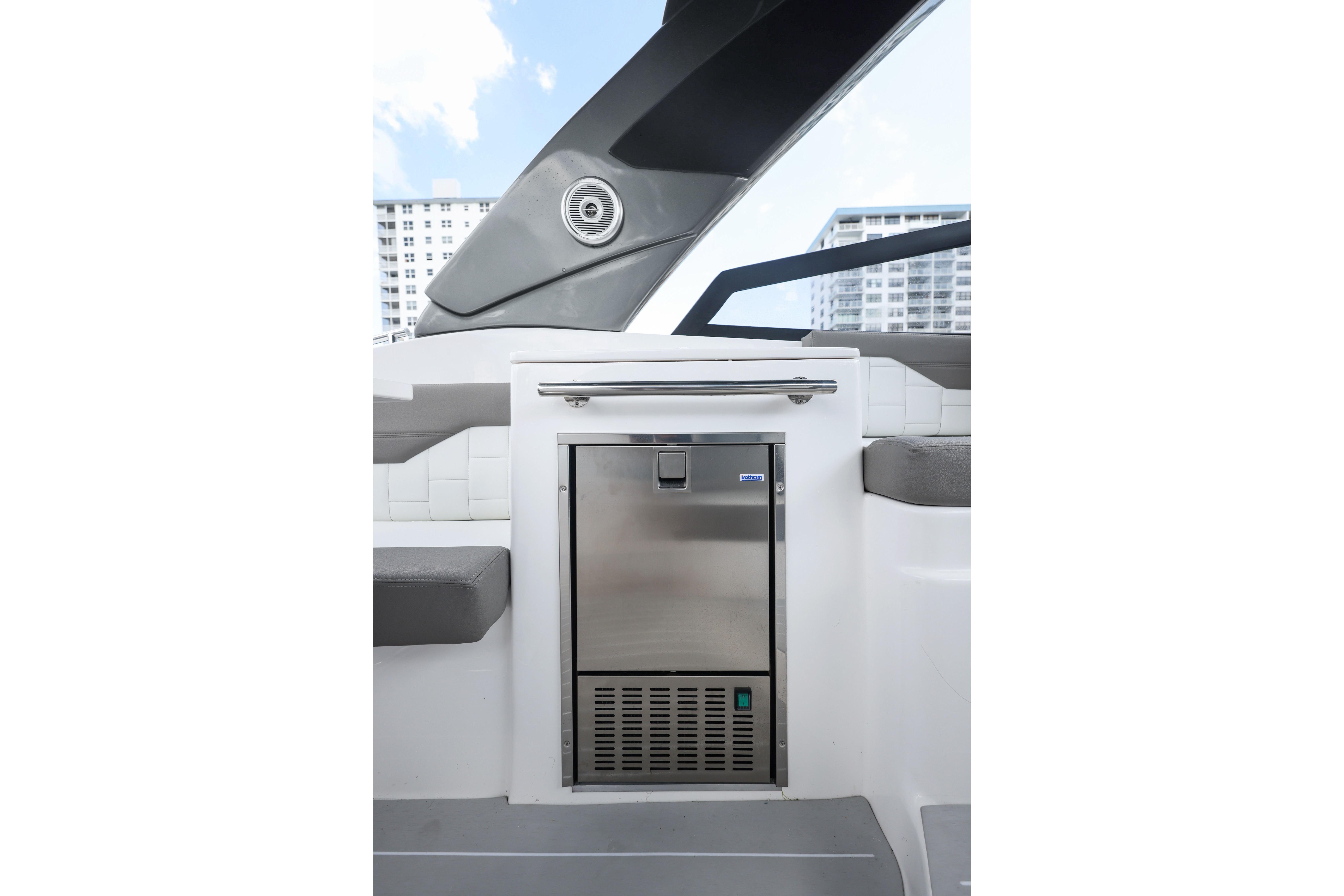 Valiatt 350GT 2025 boat interior with stainless steel refrigerator and modern seating.