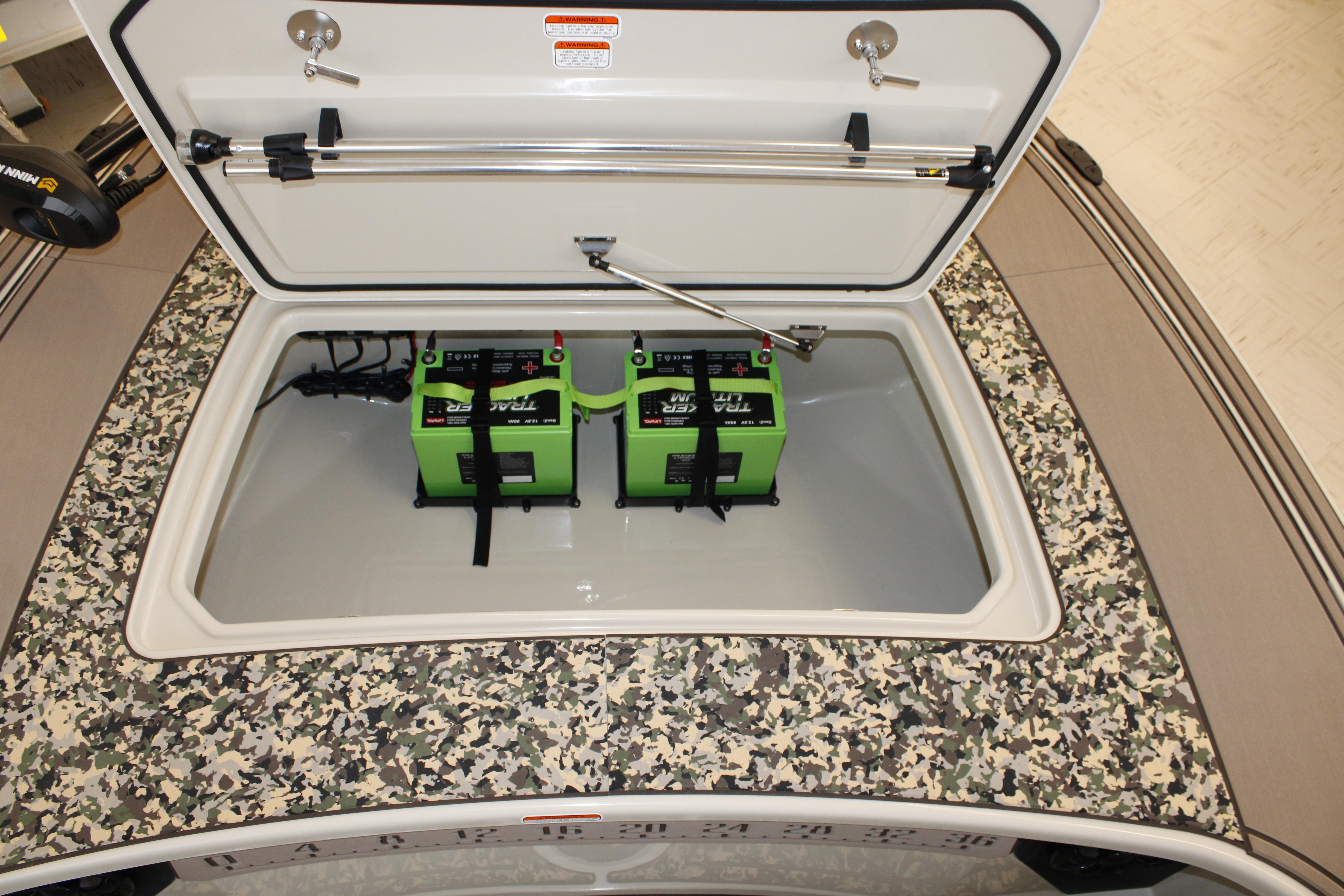 Open storage compartment with batteries in 2026 Mako 18 Pro Skiff Backwater Edition boat.