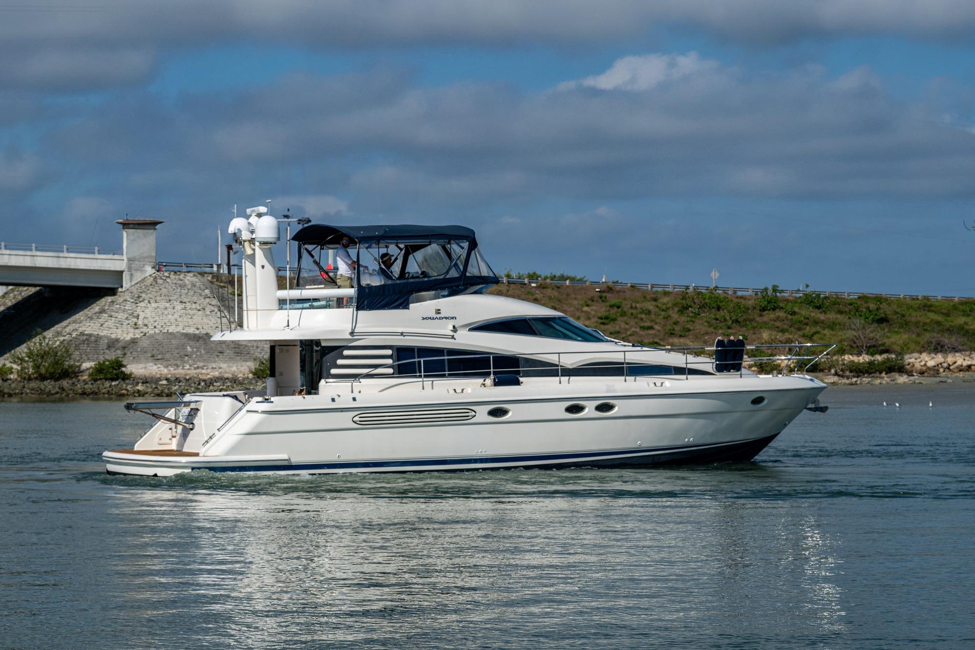 Luxury Fairline Squadron 52 yacht cruising near a bridge, 2000 model.