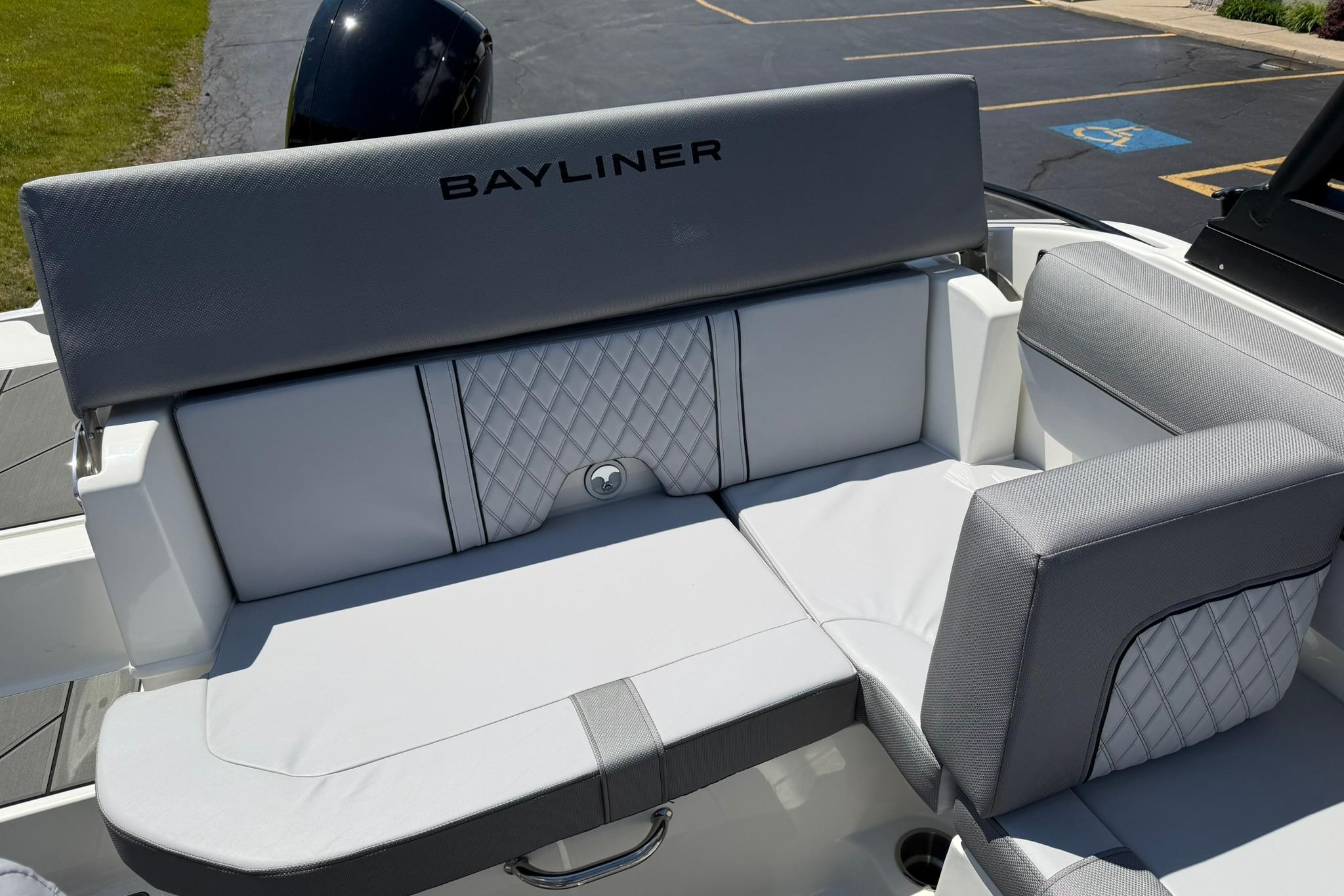 2026 Bayliner D20 boat interior with gray cushioned seating and diamond stitching.