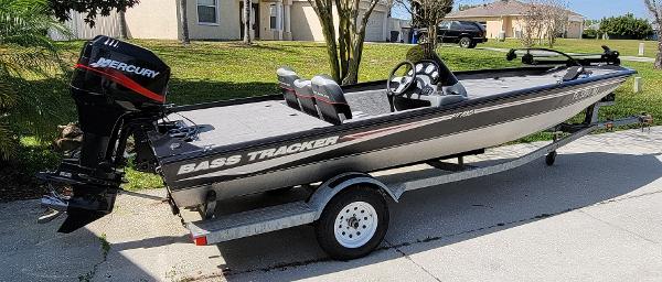 2004 Bass Tracker PRO TEAM 185 SE fishing boat on trailer with Mercury outboard motor.