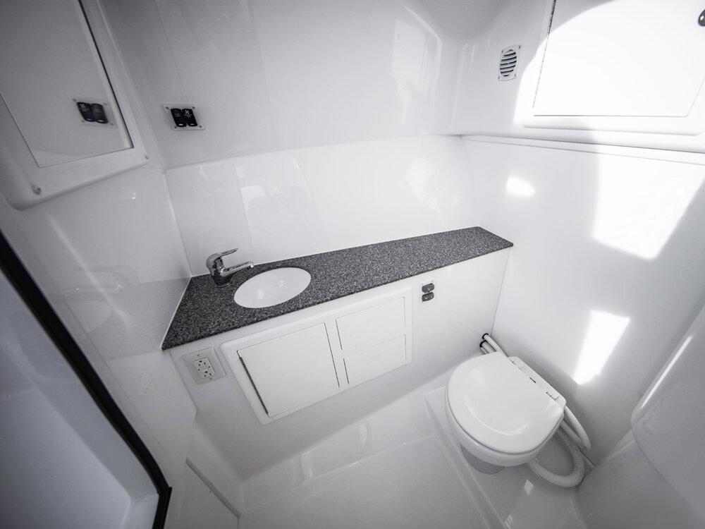2025 Albemarle 31DC boat bathroom with modern sink and toilet.