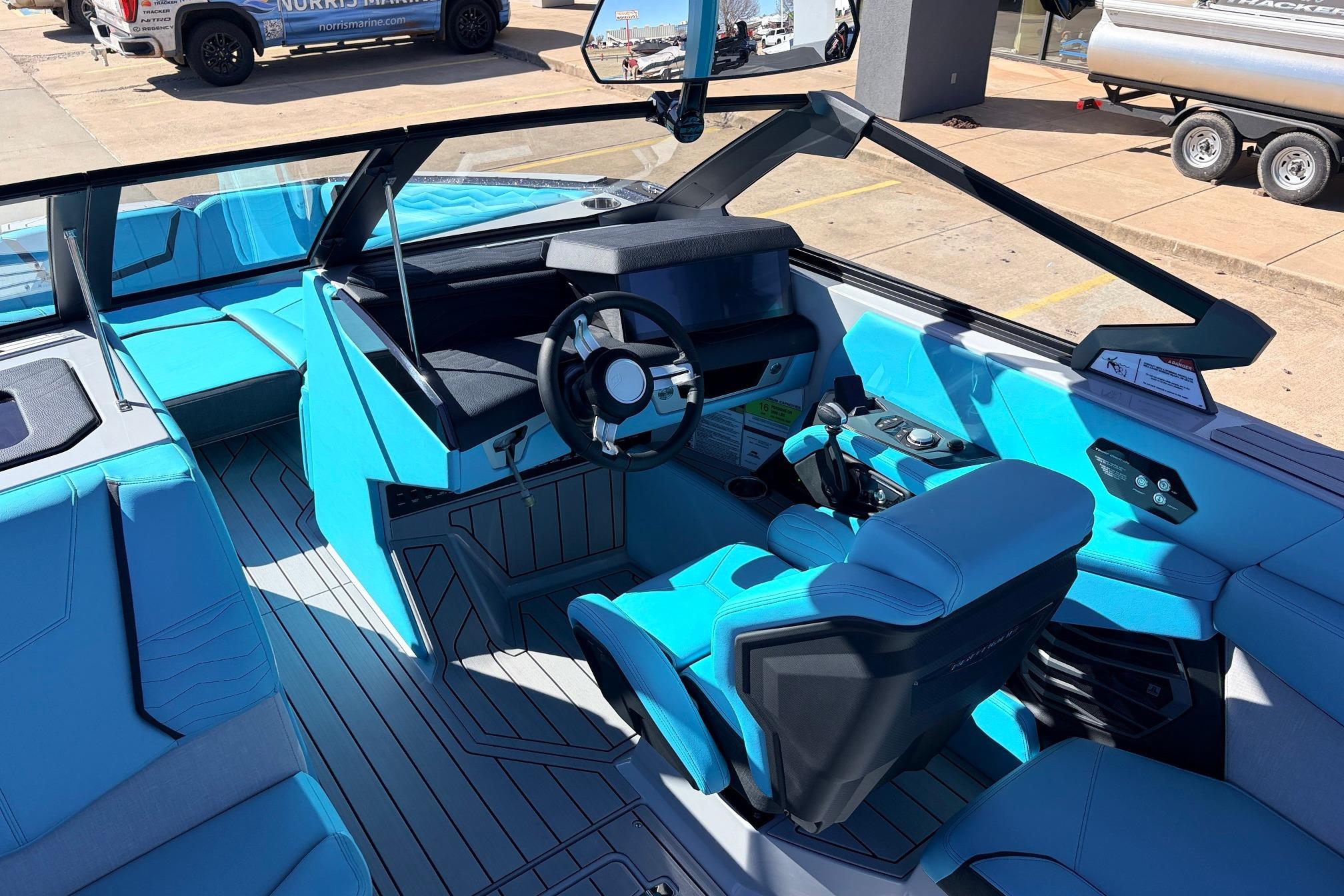2026 Nautique Super Air Nautique G23 boat interior with modern blue seating and sleek dashboard design.