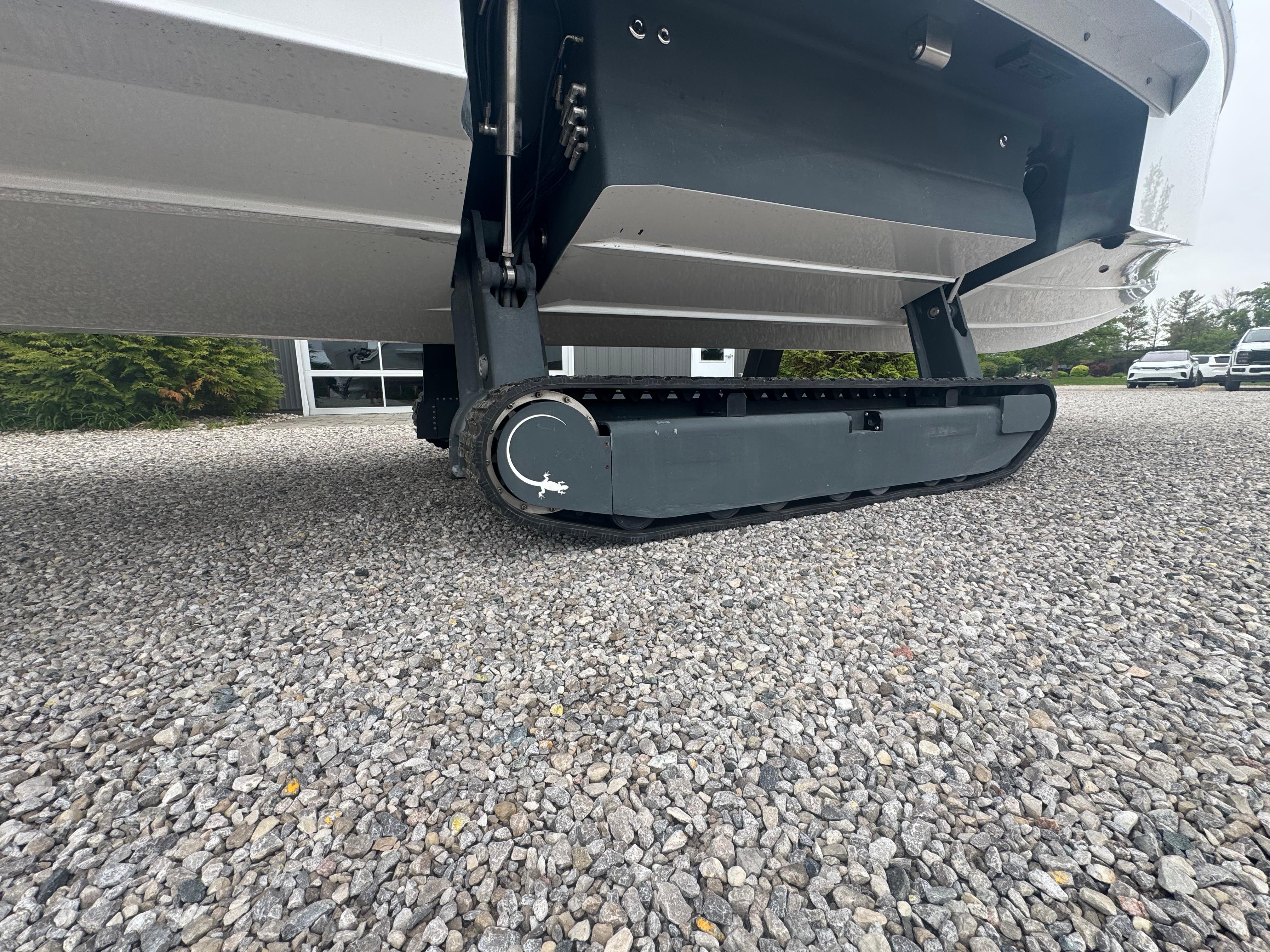 2023 Iguana Sport amphibious vehicle with track system on gravel surface.