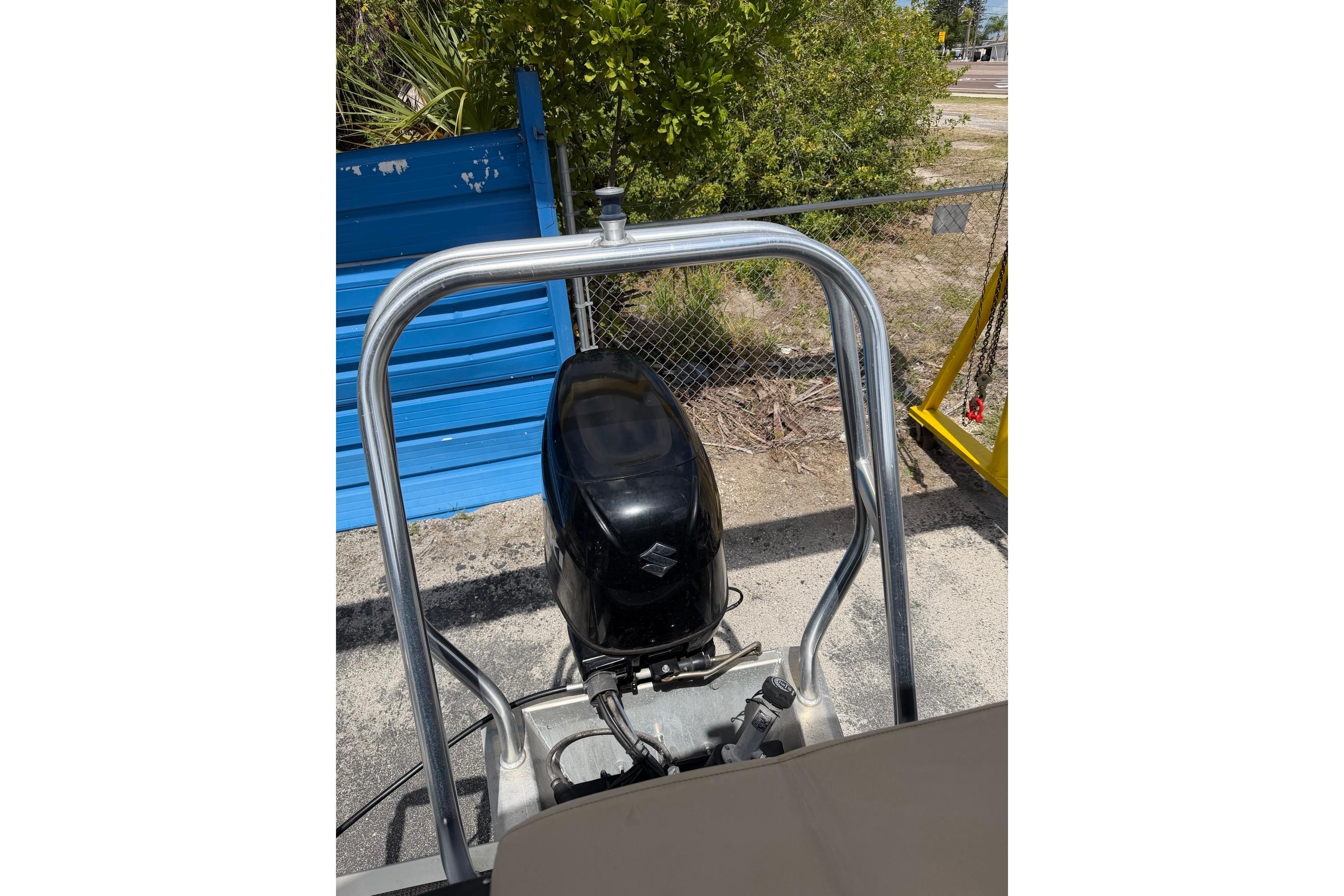 2022 Bentley Pontoons 240 CRUISE outboard motor with protective railing, parked outdoors.