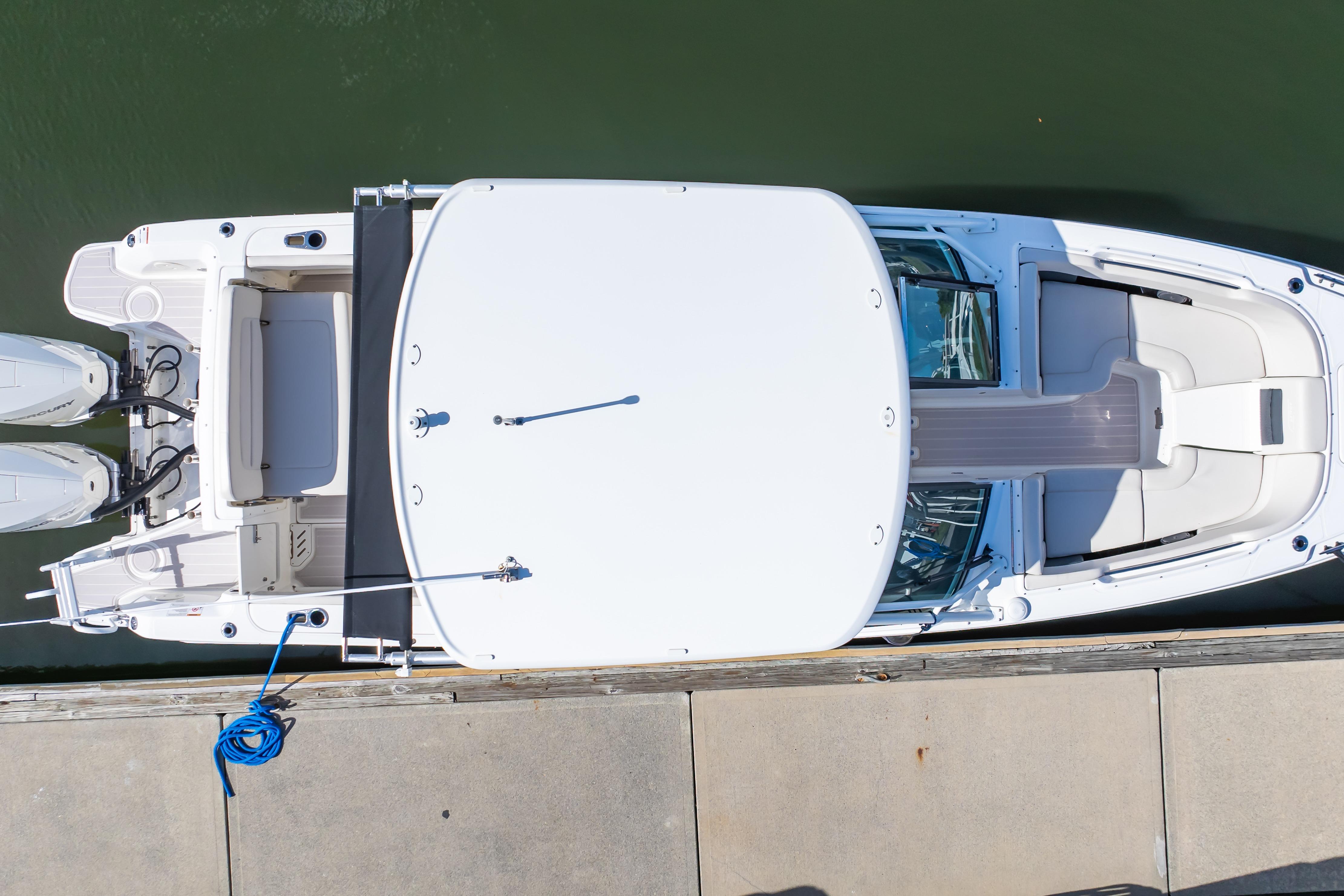 Overhead view of a 2019 Boston Whaler 270 Vantage docked, showcasing sleek design and dual engines.