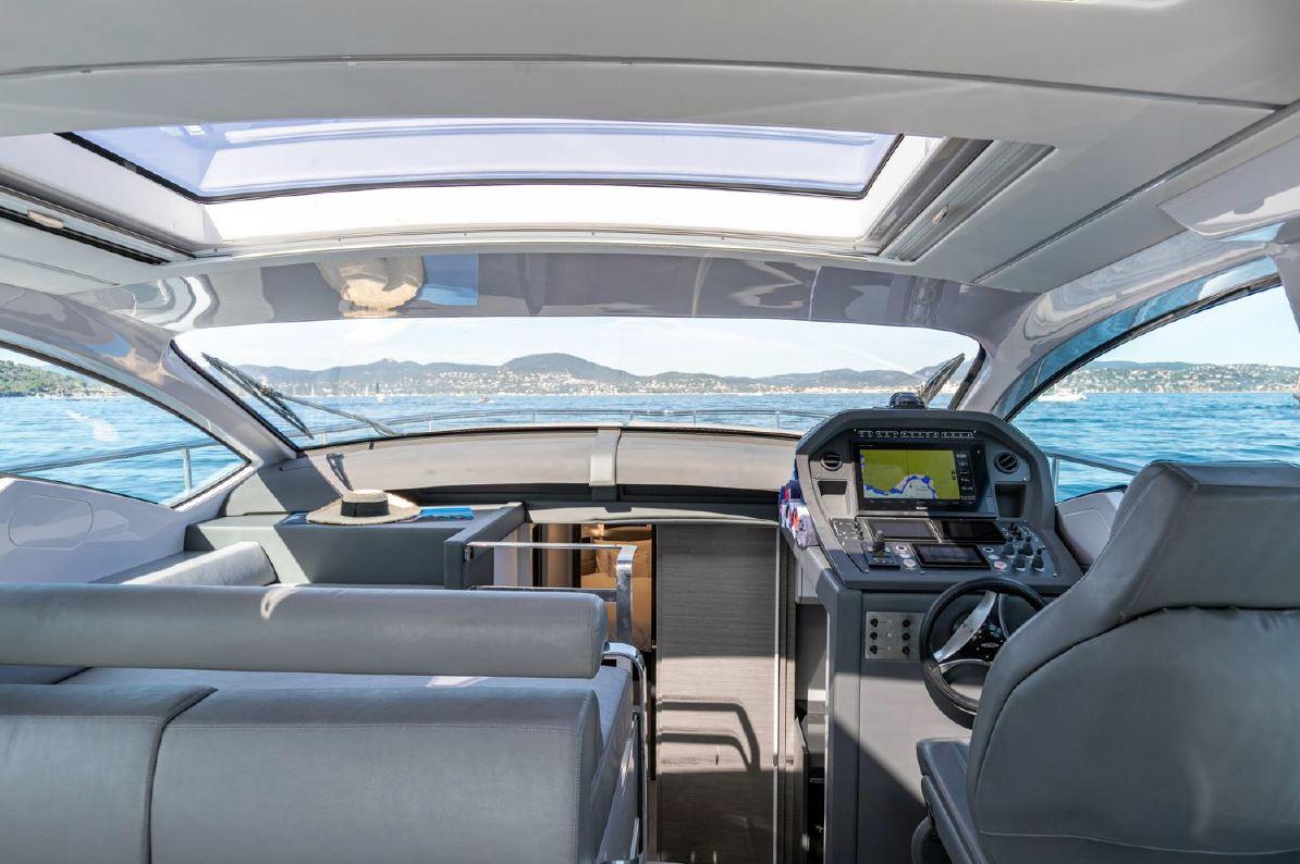 Interior view of 2018 Pershing 5x yacht cockpit with panoramic windows and modern controls.