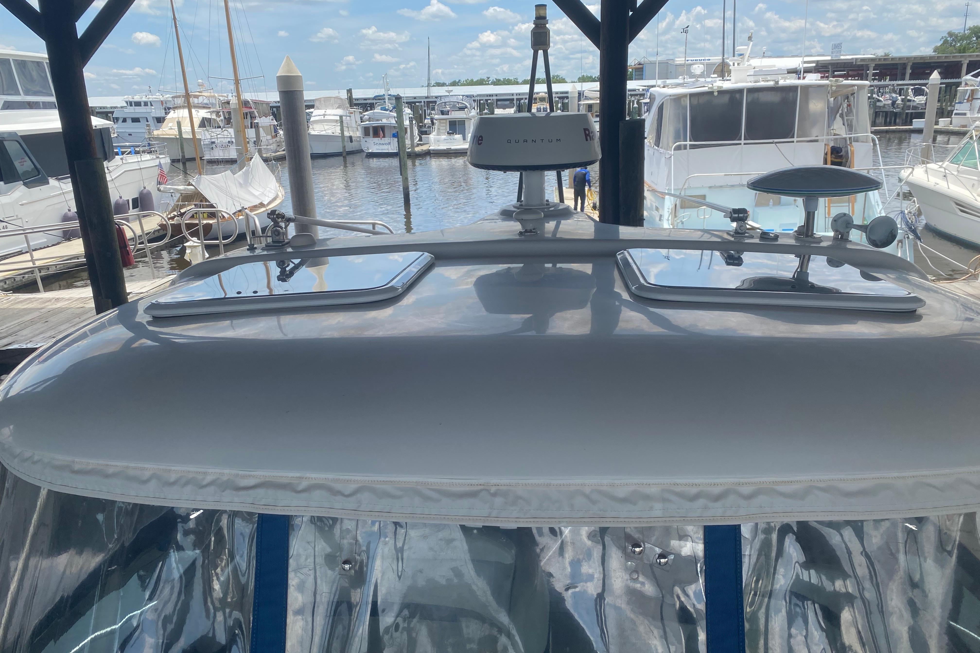 Rooftop view of a 2005 Formula boat docked at a marina, featuring radar equipment.