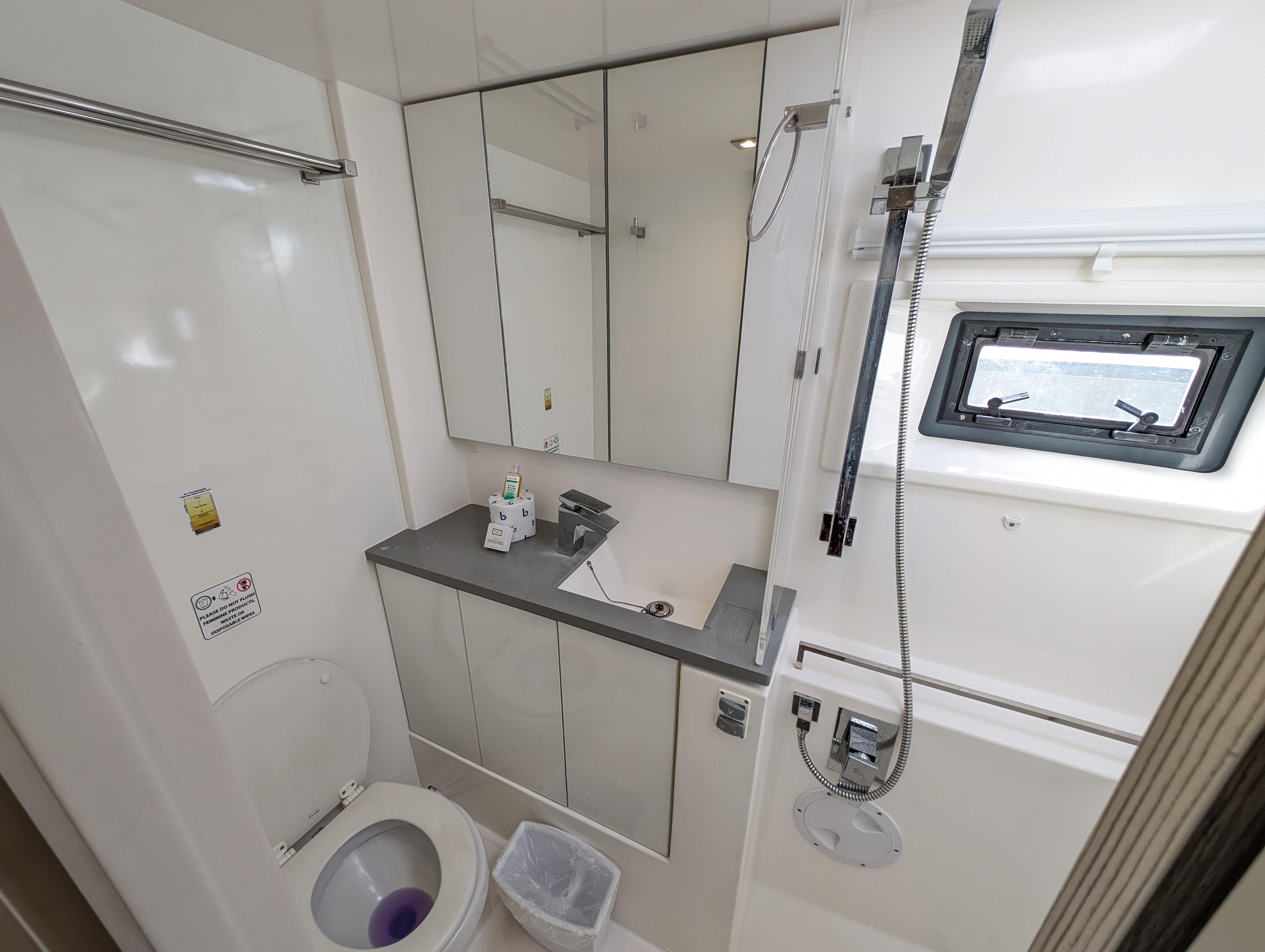 Modern bathroom in a 2020 Leopard 45 yacht with shower, sink, and toilet.