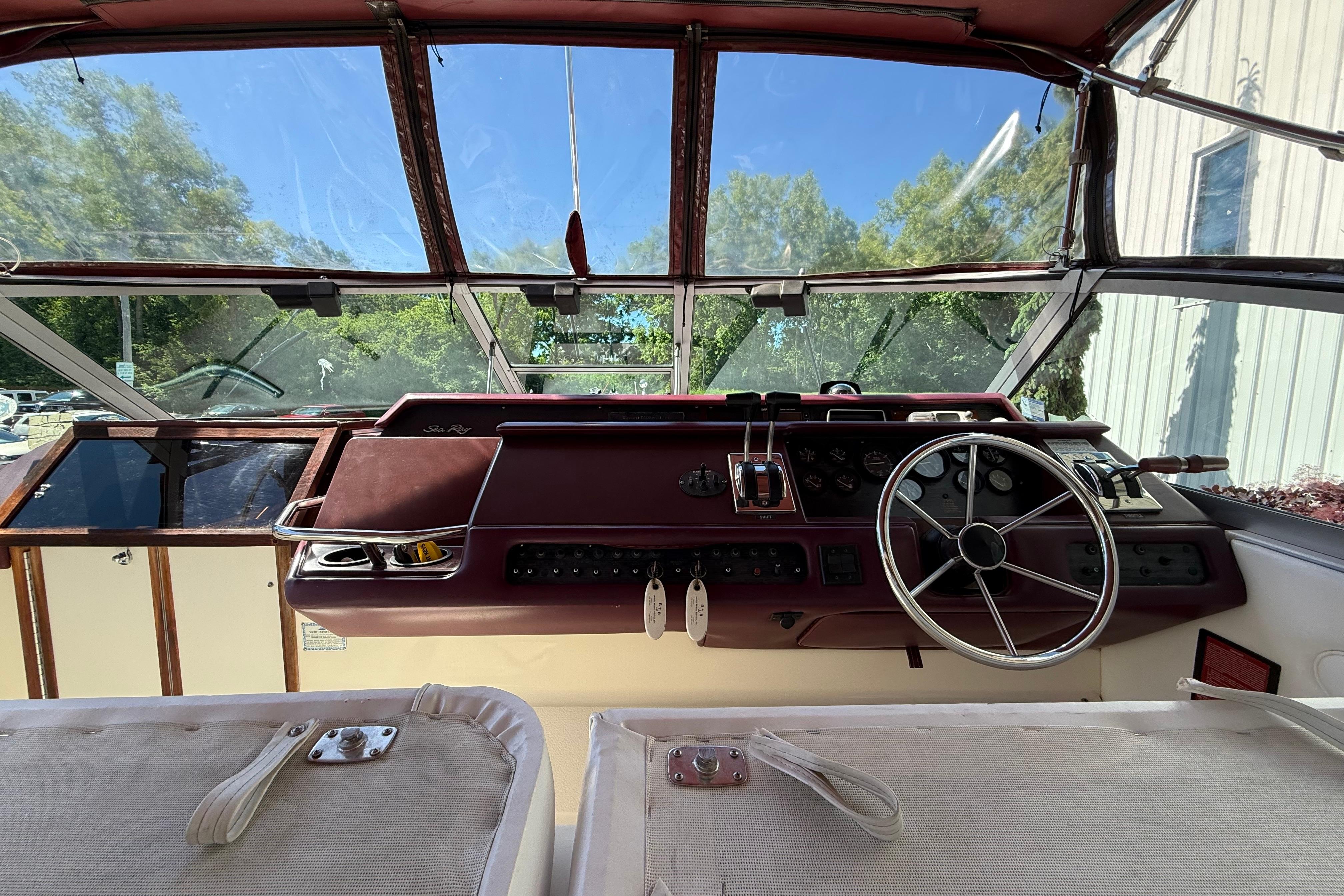 Cockpit of a 1990 Sea Ray 310 Express Cruiser with steering wheel and controls.