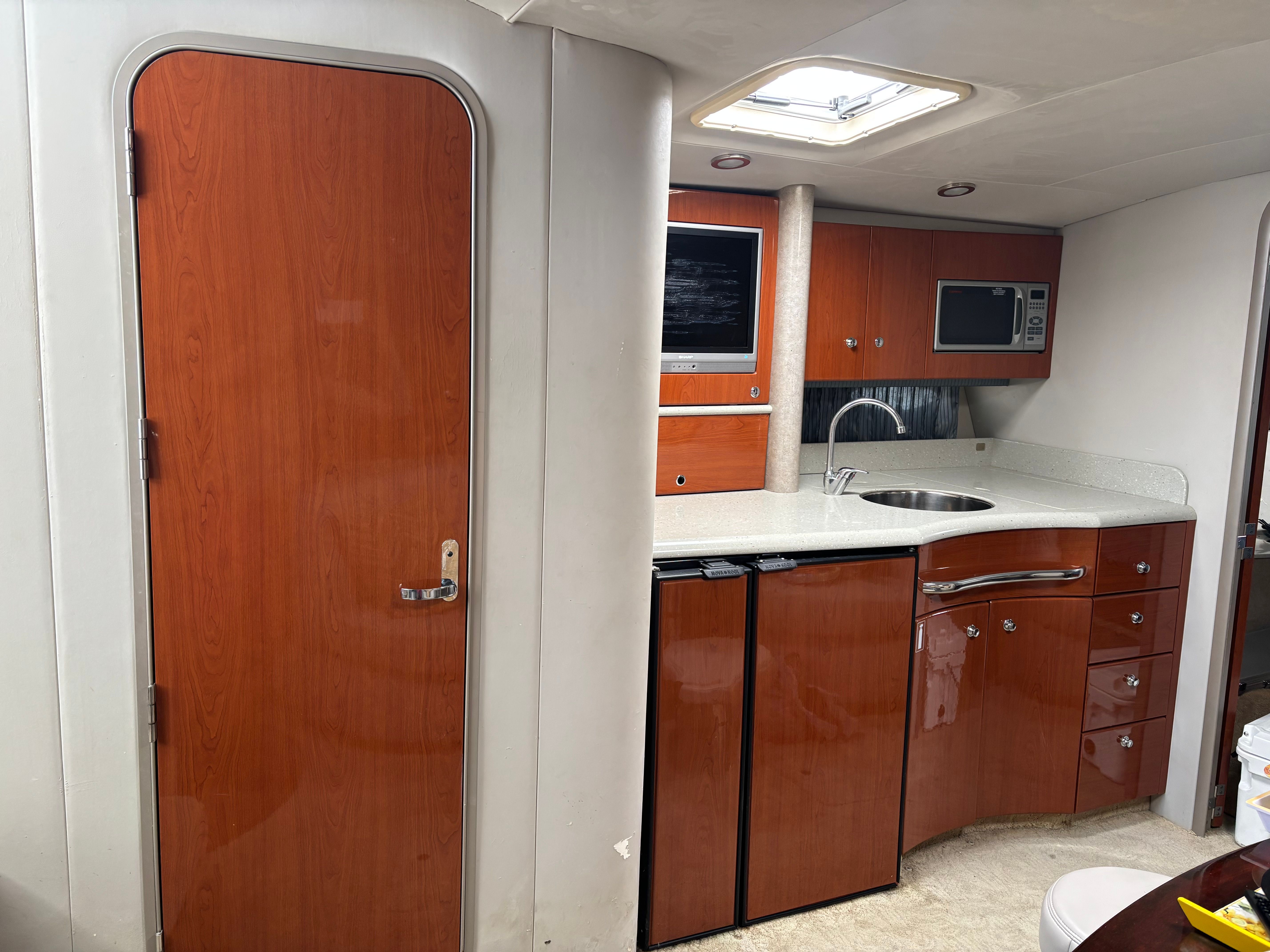 Interior of the 2005 Formula 40 Performance Cruiser with wood doors and modern kitchen.